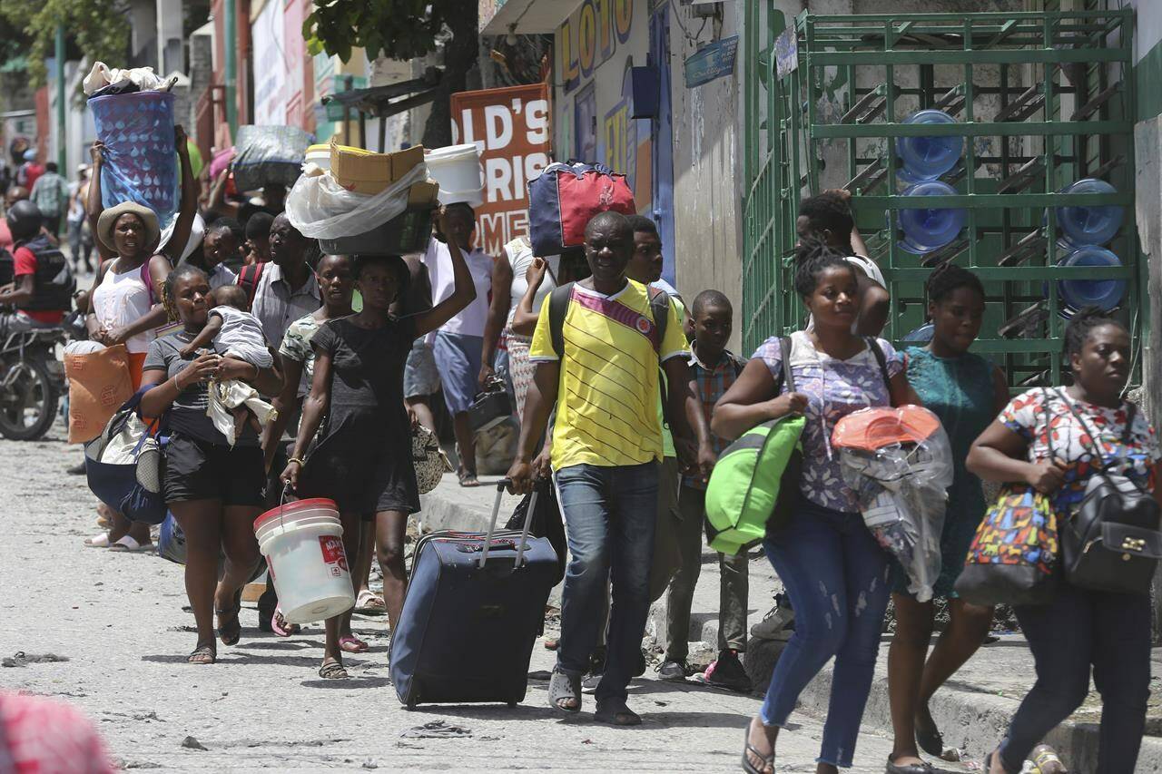 Global Affairs Canada says Ottawa aims to support people in Haiti to prevent sexual violence, ahead of a multinational military intervention in the country. Residents flee their homes to escape clashes between armed gangs in the Carrefour-Feuilles district of Port-au-Prince, Haiti, Tuesday, Aug. 15, 2023. THE CANADIAN PRESS/AP-Odelyn Joseph