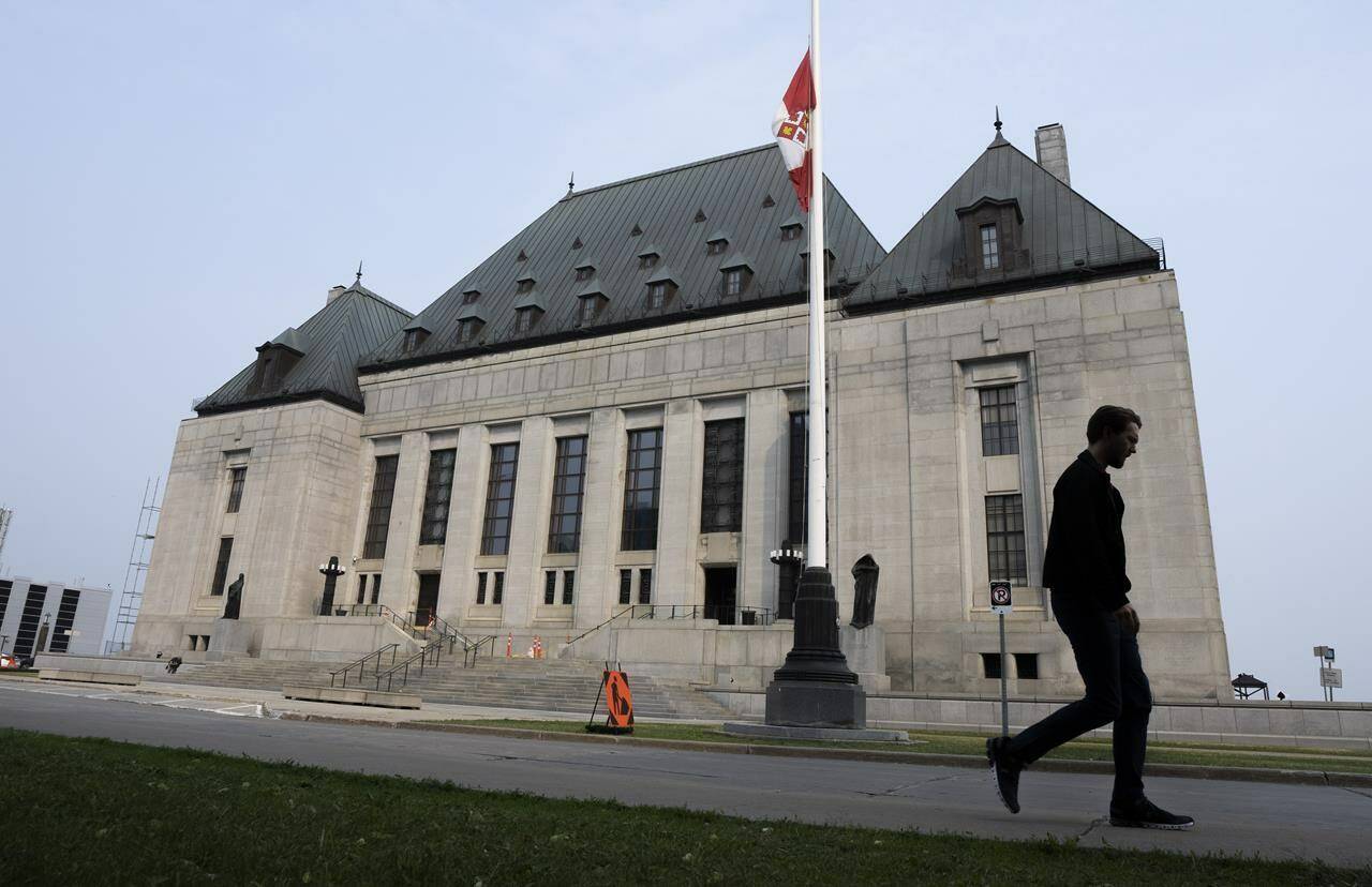 A man walks past the Supreme Court of Canada in Ottawa on June 16, 2023. THE CANADIAN PRESS/Adrian Wyld