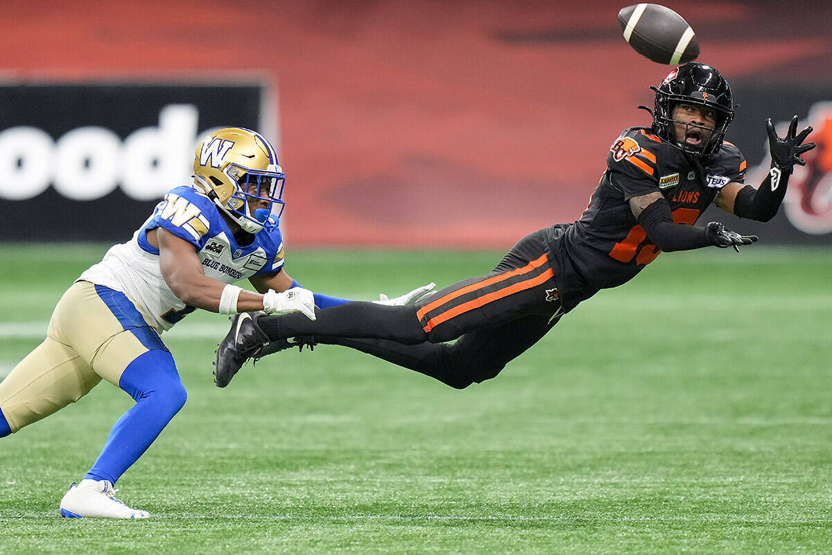 B.C. Lions’ Alexander Hollins, right, makes a diving reception as Winnipeg Blue Bombers’ Jamal Parker defends during the first half of a CFL football game, in Vancouver, on Friday, October 6, 2023. THE CANADIAN PRESS/Darryl Dyck