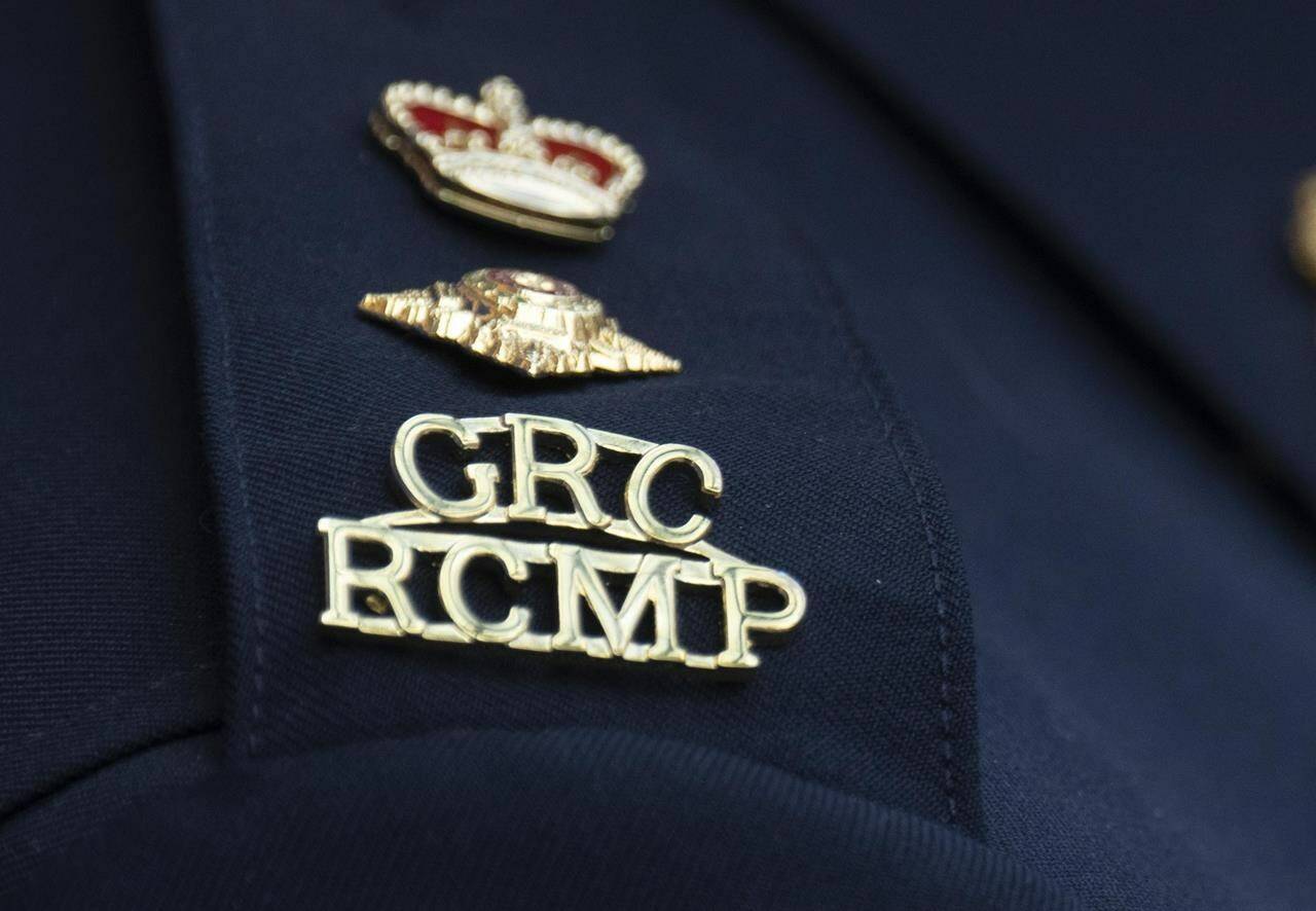 The RCMP logo is seen on the shoulder of a superintendent during a news conference, Saturday, June 24, 2023 in St. John’s, Newfoundland. RCMP in Alberta say two 14-year-old boys have died in a single-vehicle crash. THE CANADIAN PRESS/Adrian Wyld
