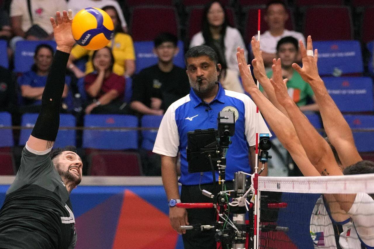 Canada’s men’s volleyball team has punched its ticket to the 2024 Paris Olympics.Canada’s Stephen Timothy Maar, left, hits the ball during their game against Italy at the Men’s Volleyball Nations League leg in Manila, Philippines on Thursday July 6, 2023. THE CANADIAN PRESS/AP/Aaron Favila