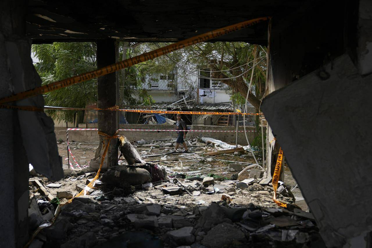 Destruction made by a rocket fired from the Gaza Strip is seen in Ashkelon, Israel, Monday, Oct. 9, 2023. Israel's military battled to drive Hamas fighters out of southern towns and seal its borders Monday as it pounded the Gaza Strip from the air. (AP Photo/Ohad Zwigenberg)