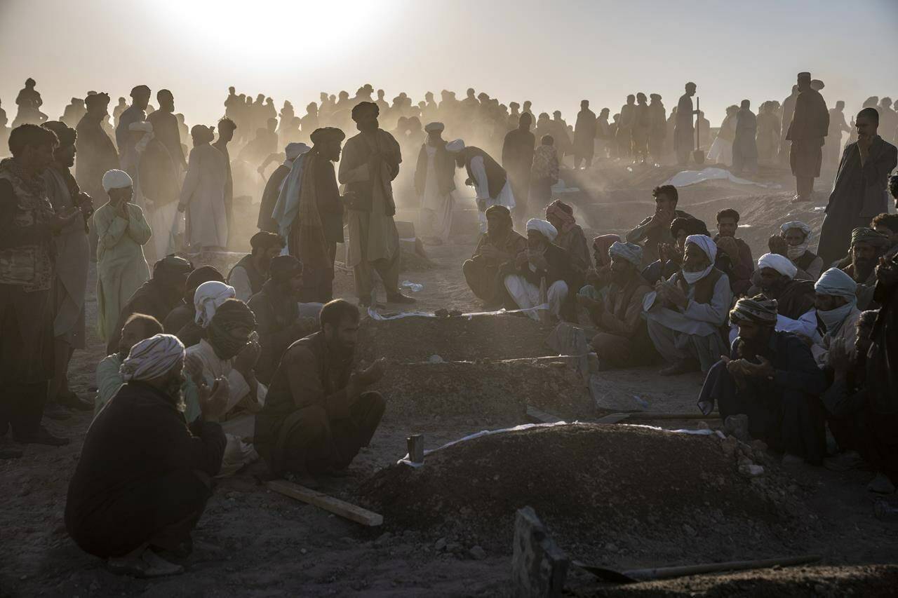 Afghans bury hundreds of people killed in an earthquake to a burial site, in a village in Zenda Jan district in Herat province, western of Afghanistan, Monday, Oct. 9, 2023. Saturday’s deadly earthquake killed and injured thousands when it leveled an untold number of homes in Herat province. (AP Photo/Ebrahim Noroozi)