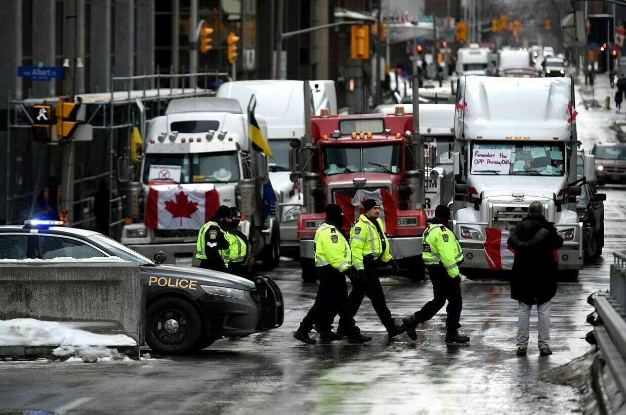 Police officers patrol on foot along Albert Street as a protest against COVID-19 restrictions marked by gridlock and the sound of truck horns reached its 14th day, in Ottawa on Thursday, Feb. 10, 2022. The court is expected to hear from Ottawa locals who lived in the midst of the “Freedom Convoy” trial as part of the criminal trial of two of the protest organizers. THE CANADIAN PRESS/Justin Tang
