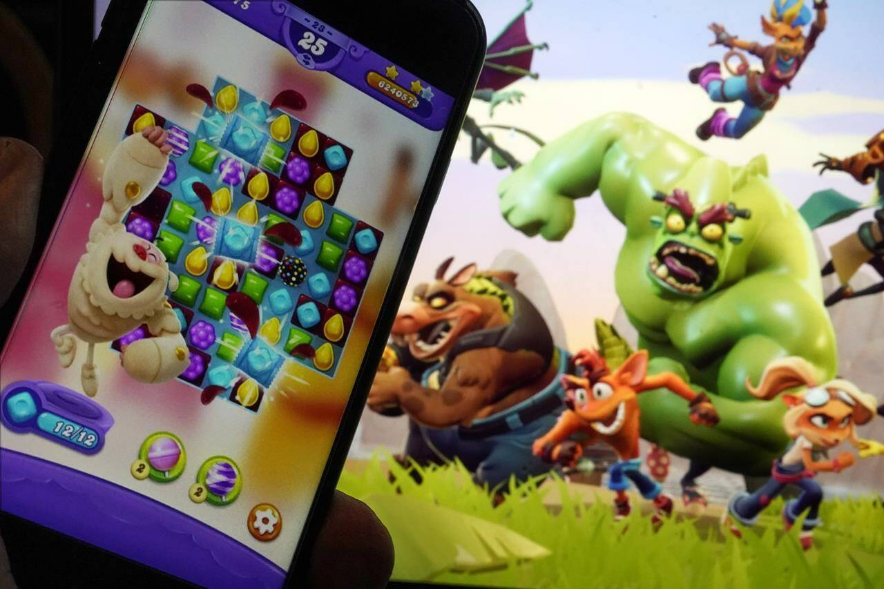 Scenes from “Candy Crush Saga,” left, by Activision Blizzard, and “Crash Team Rumble,” from Activision Publishing, are shown in this photo, in New York, Wednesday, June 21, 2023. Microsoft’s purchase of video game maker Activision Blizzard won final approval Friday, Oct. 13, from Britain’s competition watchdog, reversing its earlier decision to block the $69 billion deal and removing a last obstacle for one of the largest tech transactions in history. (AP Photo/Richard Drew)
