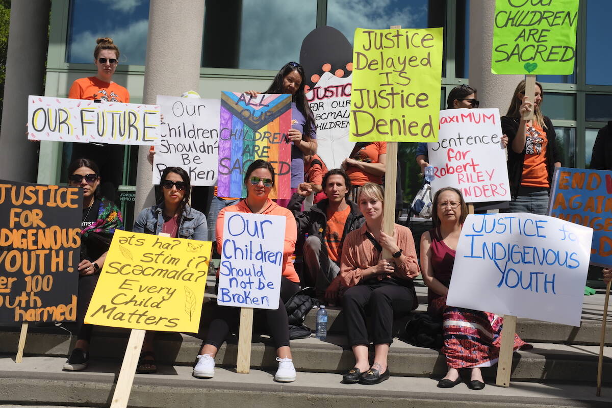 Members of Kelowna’s Indigneous community carried signs saying “Maximum sentence for Robert Riley Saunders,” and “Justice for Indigenous youth,” outside of the courthouse during Saunders’ sentencing. (Jacqueline Gelineau/Capital News)