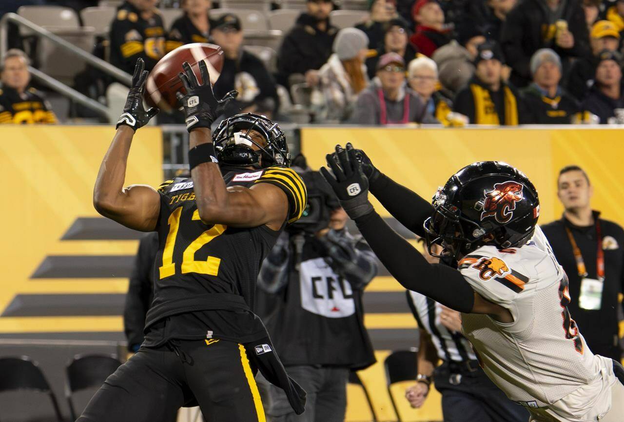 Hamilton Tiger-Cats wide receiver Tim White (12) scores a touchdown against the B.C. Lions during first half CFL football game action in Hamilton, Ont. on Friday, October 13, 2023. THE CANADIAN PRESS/Peter Power