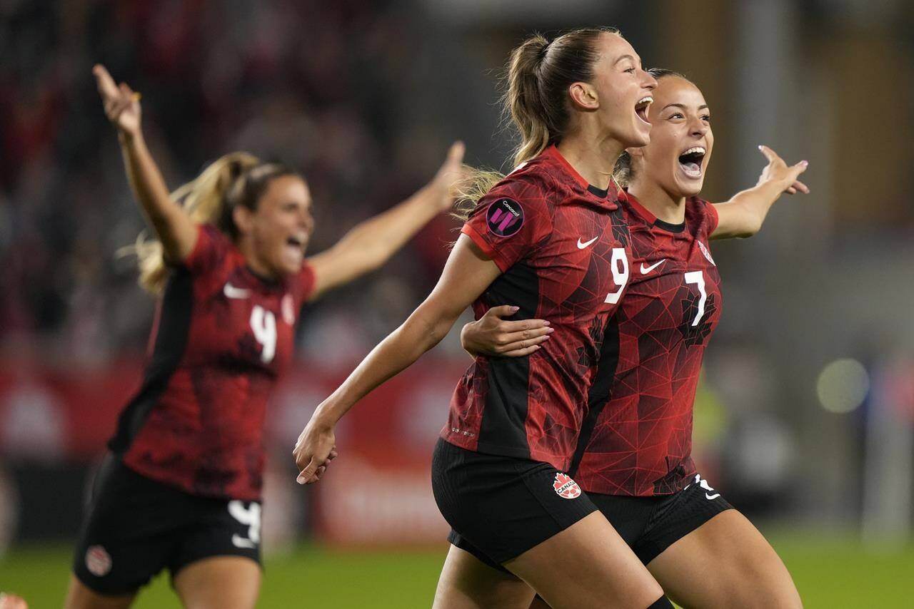 Canada’s Jordyn Huitema, 9, celebrates her goal with teammates Julia Groos, 7, and Shelina Zadorshy, 4, during second half CONCACAF women’s championship soccer series match against Jamaica in Toronto on Tuesday Sept. 26, 2023. THE CANADIAN PRESS/Nathan Denette