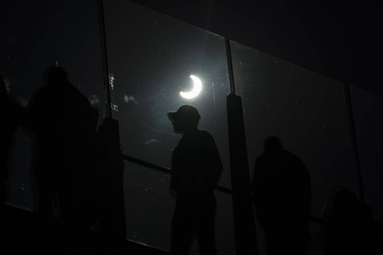 People watch a rare “ring of fire” solar eclipse along the Las Vegas Strip, Saturday, Oct. 14, 2023, in Las Vegas. (AP Photo/John Locher)