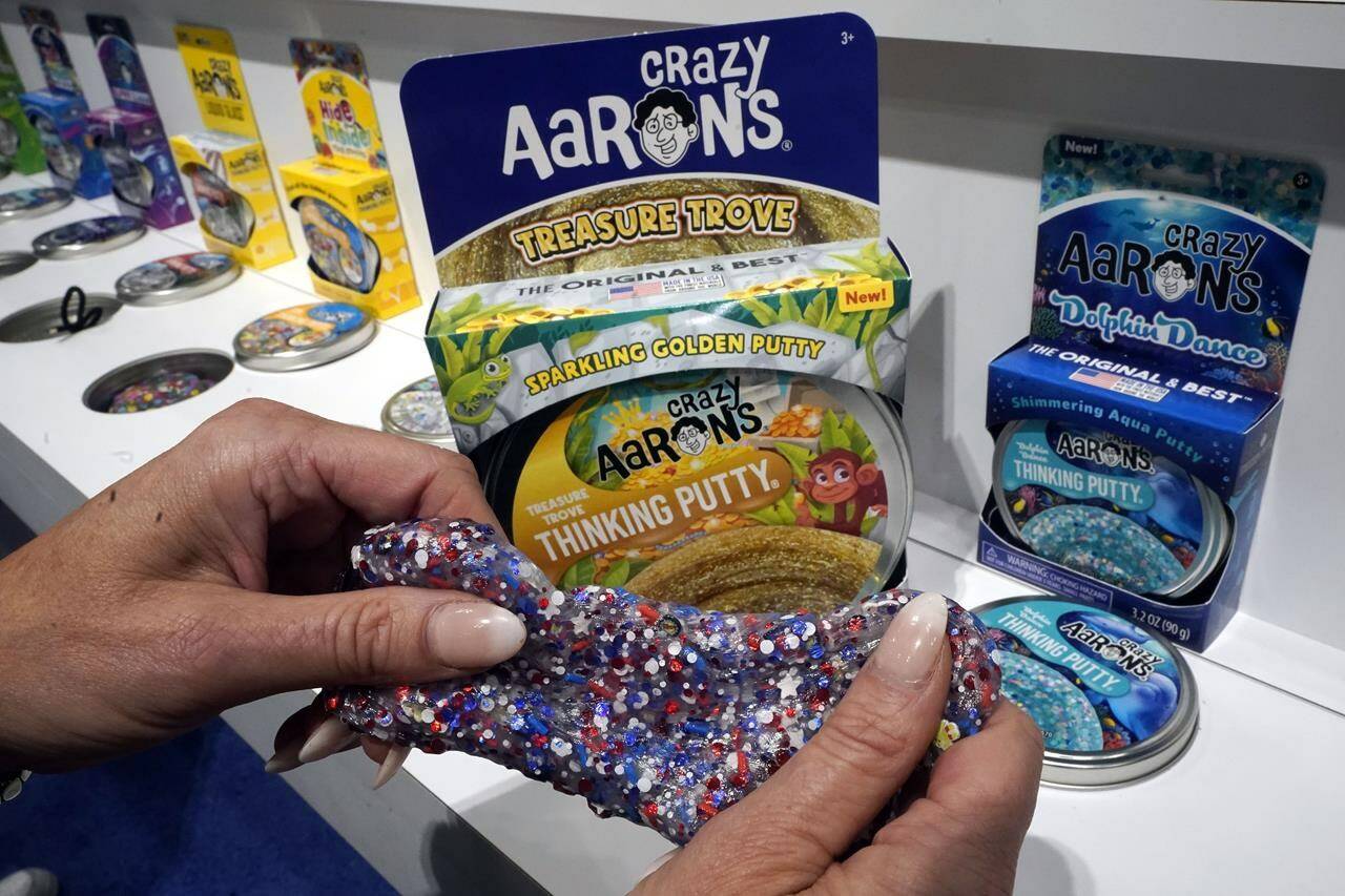 A selection of Crazy Aaron's Thinking Putty kits are displayed at the 2023 Toy Fair, at New York's Javits Center, Monday, Oct. 2, 2023. Crazy Aaron’s has expanded beyond its Thinking Putty to add activity kits that teach kids problem solving like how magnets work with putty. (AP Photo/Richard Drew)