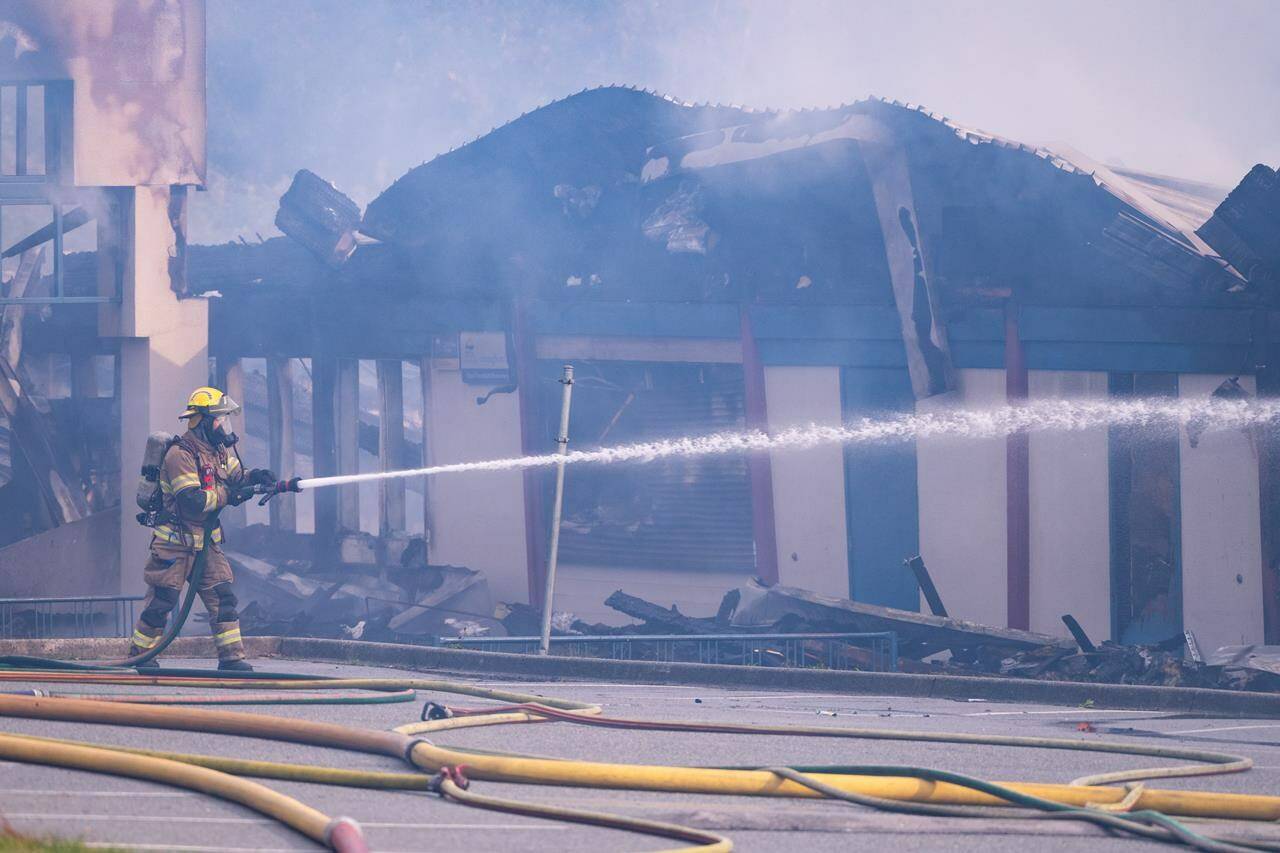 Fire crews continue to put out the fire at Hazel Trembath Elementary School in Port Coquitlam, B.C., on Saturday, Oct. 14, 2023. Plans are underway to bring school life back to normal as quickly as possible for students and teachers after a Metro Vancouver elementary school was destroyed in a suspicious weekend fire. THE CANADIAN PRESS/Ethan Cairns