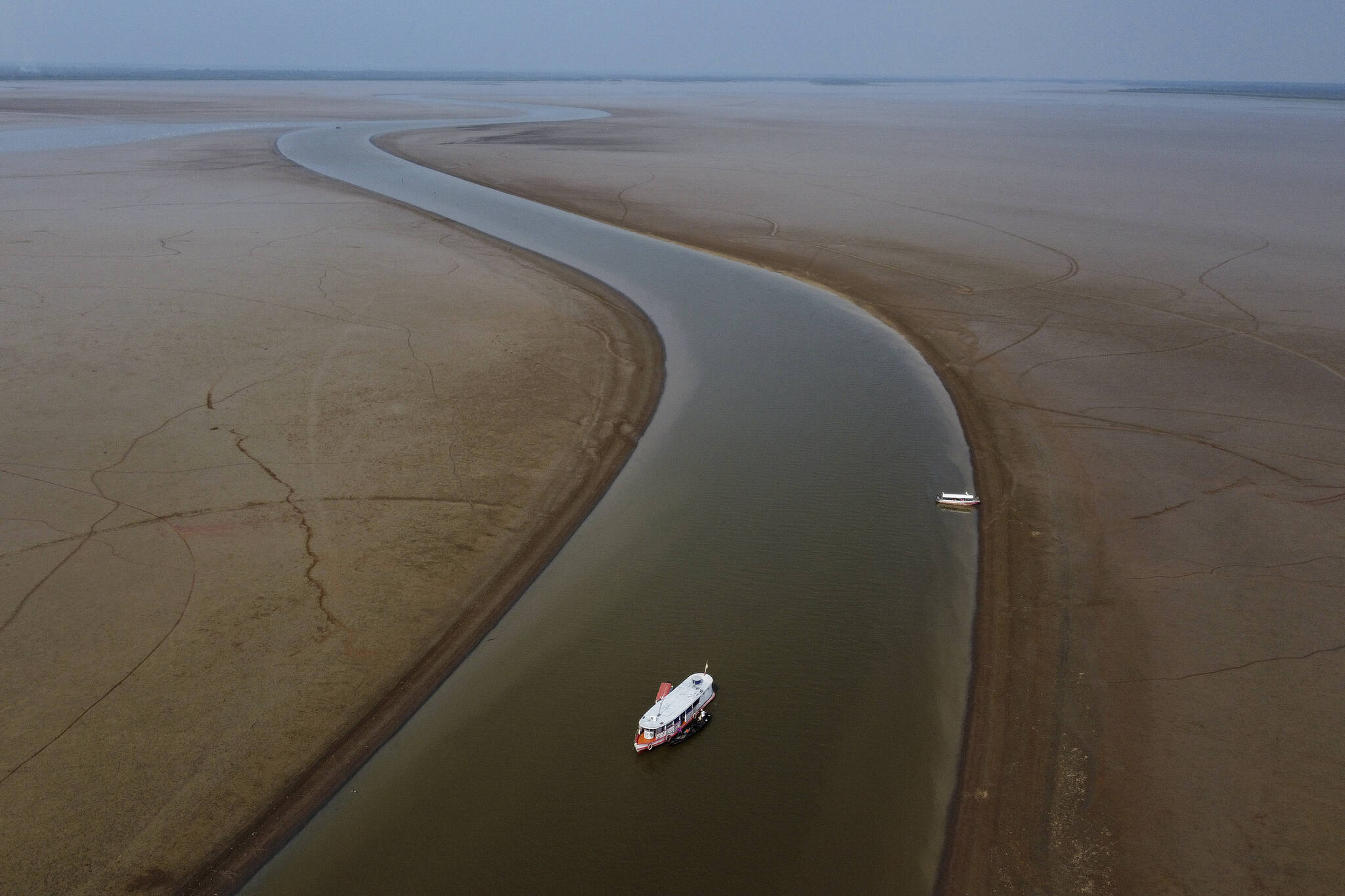 A boat travels through a section of the Amazon River affected by a severe drought in the state of Amazonas, near Manacapuru, Brazil, Wednesday, Sept. 27, 2023. (AP Photo/Edmar Barros)