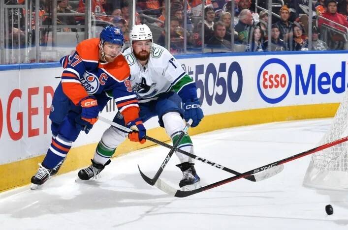 Edmonton’s Connor McDavid battles with Vancouver’s Filip Hronek during Saturday’s game in Edmonton. The Canucks would win 4-3 despite being outshot 40-16. Photo courtesy Edmonton Oilers