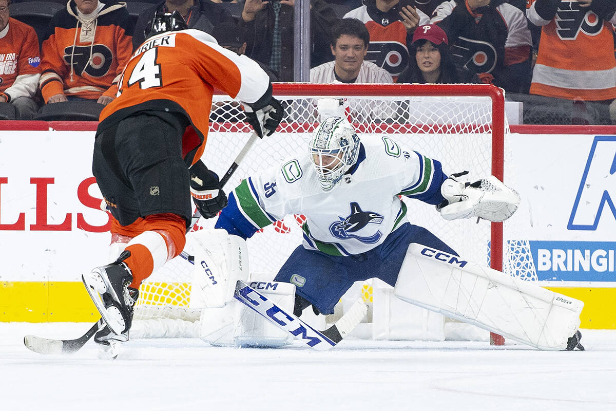 Philadelphia Flyers’ Sean Couturier, left, converts a penalty shot against Vancouver Canucks’ Thatcher Demko, right, during the first period of an NHL hockey game, Tuesday, Oct. 17, 2023, in Philadelphia. (AP Photo/Chris Szagola)
