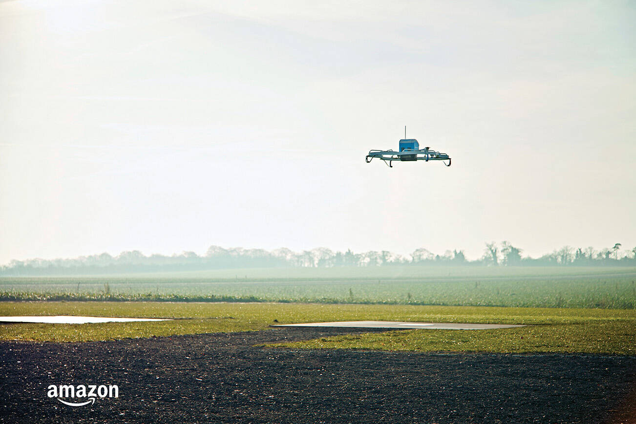This Dec. 7, 2016, photo provided by Amazon shows an Amazon Prime Air drone in Cambridgeshire, United Kingdom. Amazon announced the successful delivery of a package by drone to a customer in Cambridge, U.K., part of a small testing program. With drones, Amazon aims to make deliveries in 30 minutes or less. Packages must weigh five pounds or less and can only be delivered during the day and in clear weather. Amazon plans to expand the trial to hundreds of users. (Amazon via AP)