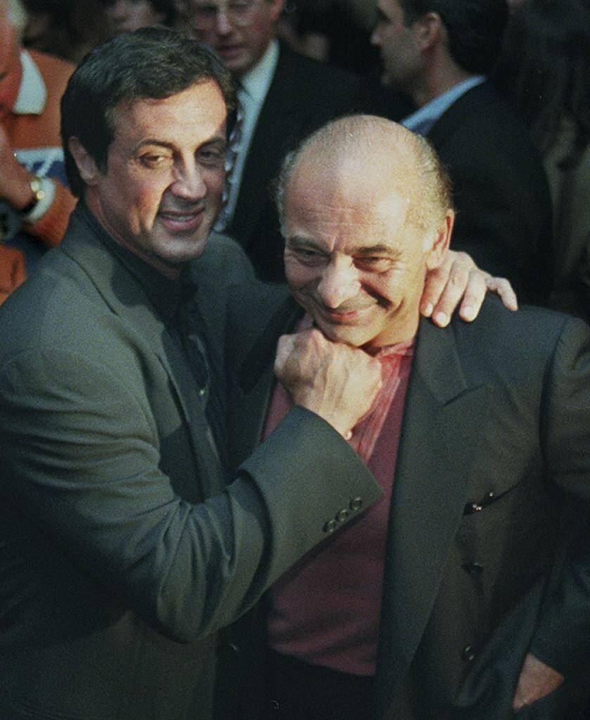 FILE - Sylvester Stallone, left, mugs with “Rocky” co-star Burt Young before a screening of the 1976 film to celebrate its 20th anniversary, Nov. 15, 1996, in Beverly Hills, Calif. Burt Young, the Oscar-nominated actor who played Paulie, the rough-hewn, mumbling-and-grumbling best friend, corner-man and brother-in-law to Sylvester Stallone in the “Rocky” franchise, has died. Young died Oct. 8, 2023 in Los Angeles. (AP Photo/Chris Pizzello, File)