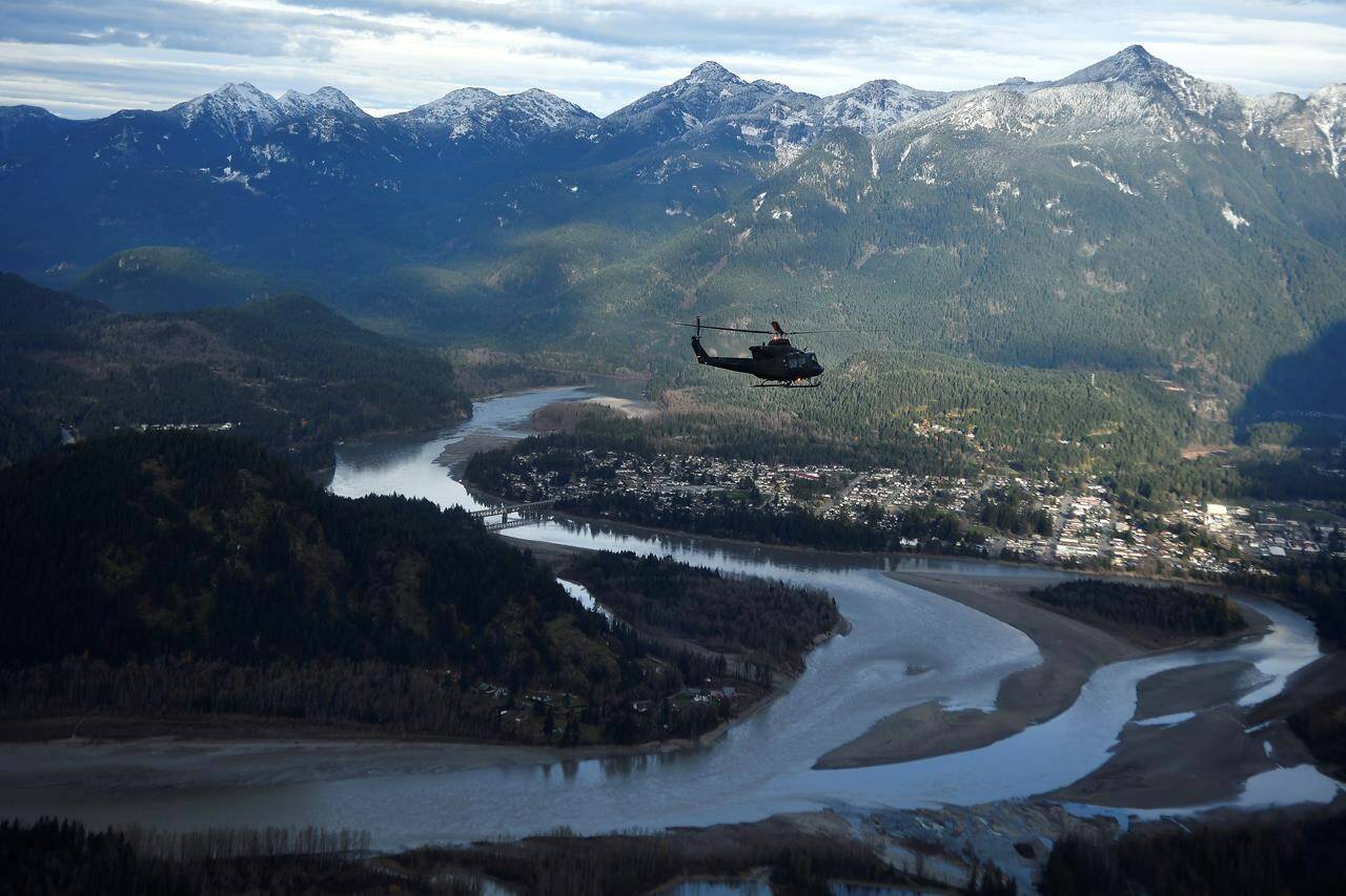One of three Royal Canadian Air Force helicopters surveys the Fraser Valley after rainstorms lashed the western Canadian province of British Columbia, triggering landslides and floods, shutting highways, near Abbotsford, B.C., Sunday, Nov. 21, 2021. The B.C. government says it has finalized a deal with Washington state and several First Nations to work together on flood-risk mitigation and salmon habitat restoration for the Nooksak and Sumas watersheds on the Canada-U. S. border. THE CANADIAN PRESS/Jennifer Gauthier