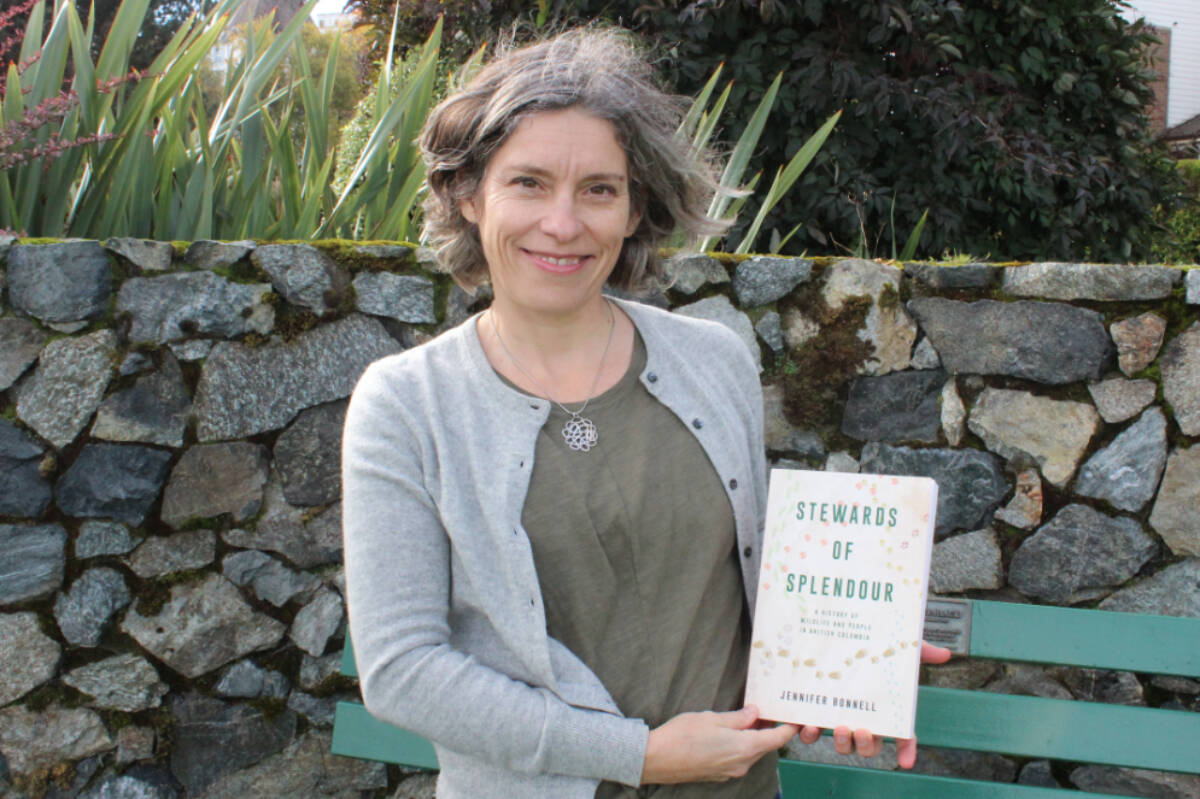 Jennifer Bonnell posing with her book Stewards of Splendor: A History of Wildlife and People in British Columbia. (Ella Matte/News Staff)