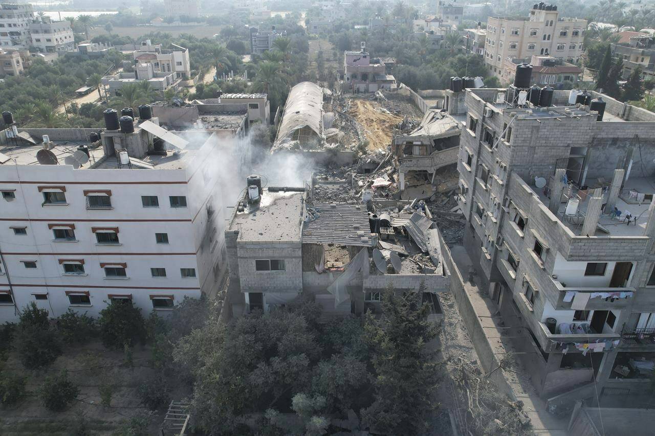 A building destroyed in an Israeli airstrike on the Gaza Strip is seen in Deir Al-Balah, Tuesday, Oct. 24, 2023. (AP Photo/Hatem Moussa)