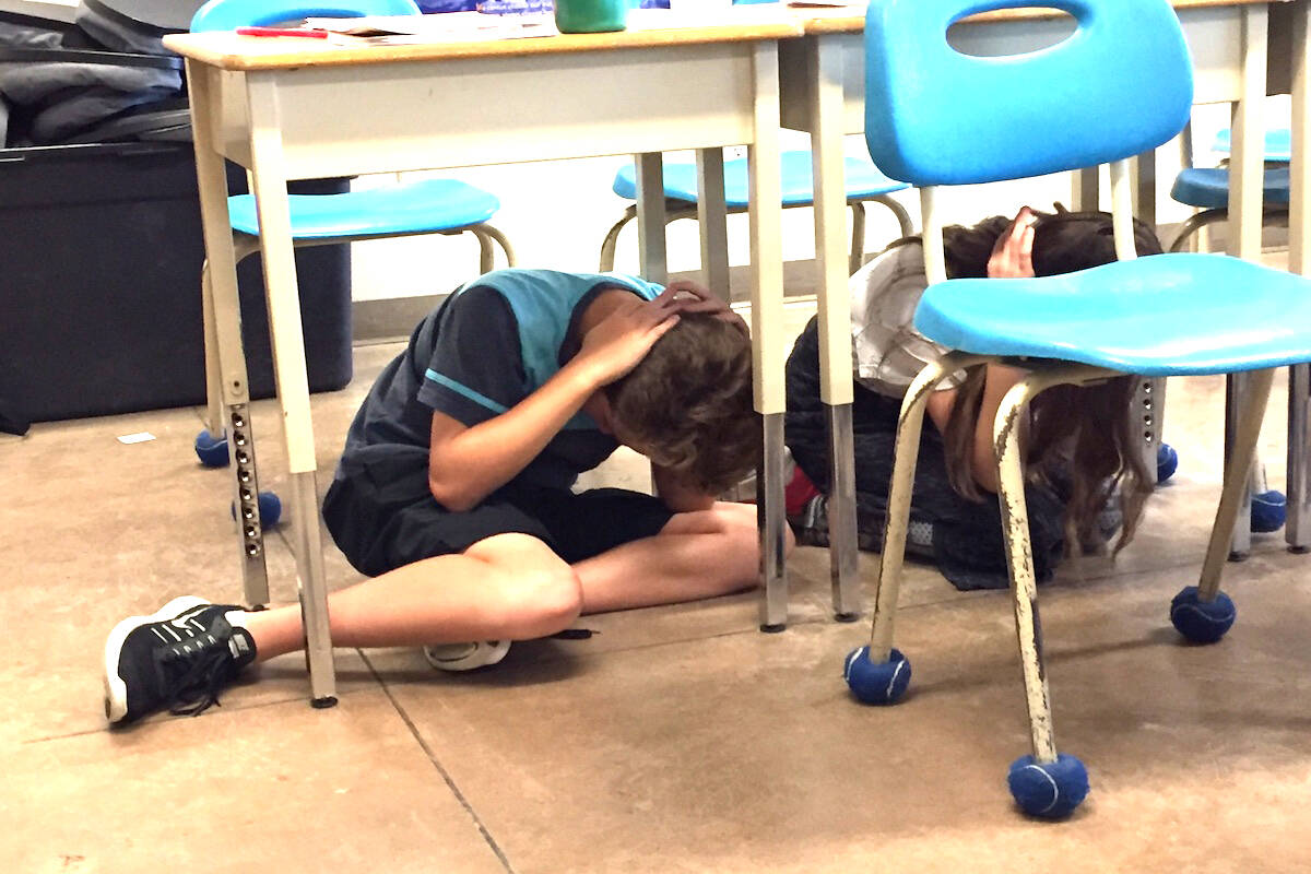 B.C. students hide under their classroom desks during an earthquake drill. Photo Credit: Barry Gerding/Black Press