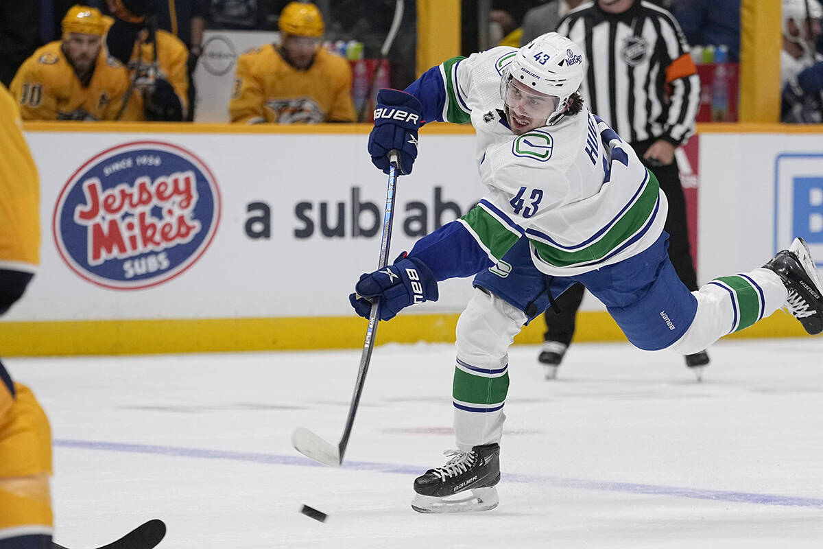 Vancouver Canucks defenceman Quinn Hughes (43) shoots the puck against the Nashville Predators during the first period of an NHL hockey game Tuesday, Oct. 24, 2023, in Nashville, Tenn. (AP Photo/George Walker IV)
