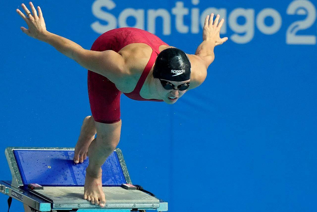 Canada’s Maggie Mac Neil prepares to enter the water in the women’s 50m freestyle swim event at the Pan American Games in Santiago, Chile, Tuesday, Oct. 24, 2023. THE CANADIAN PRESS/Frank Gunn