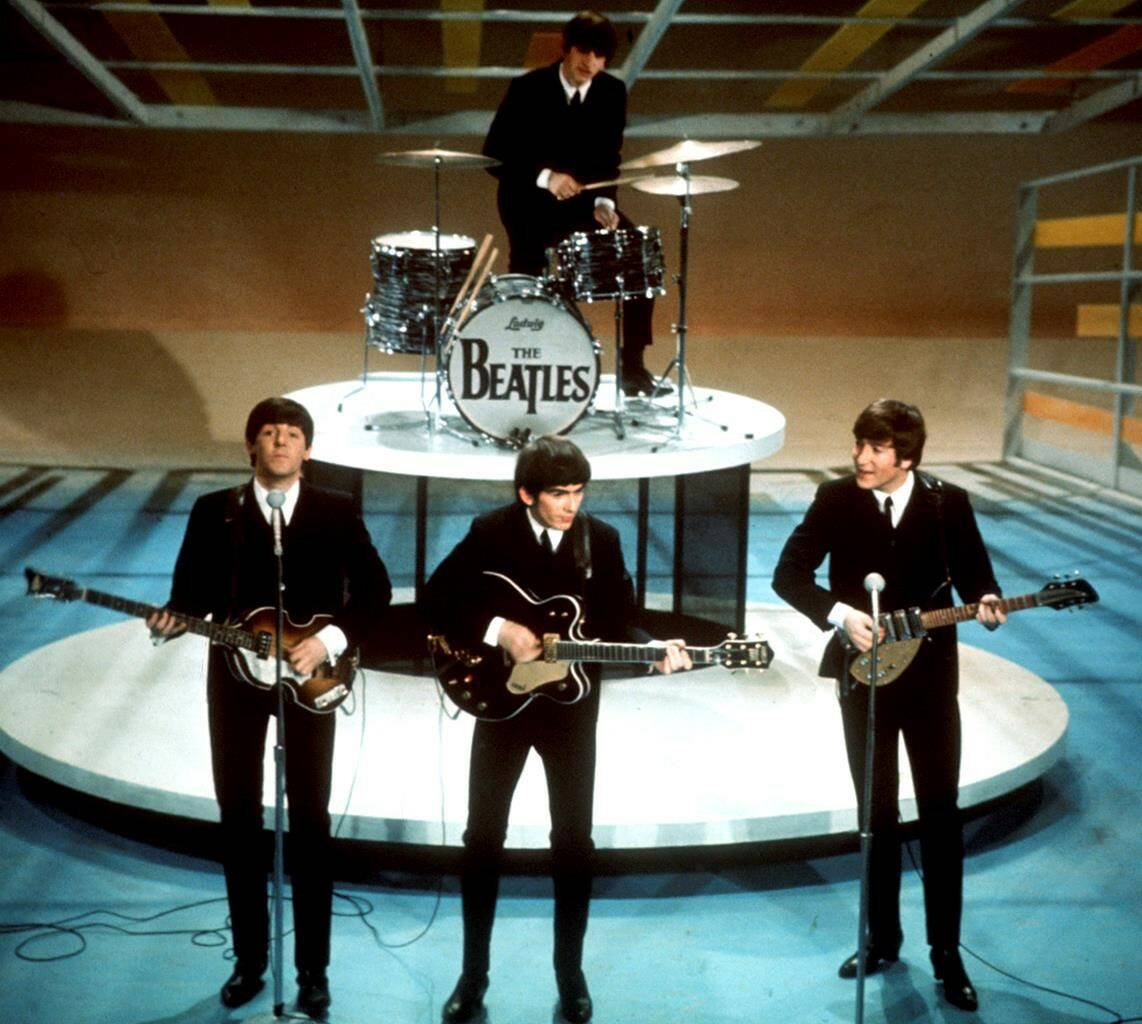 FILE -The Beatles, foreground from left, Paul McCartney, George Harrison, John Lennon and Ringo Starr on drums perform on the CBS “Ed Sullivan Show” in New York on Feb. 9, 1964. Sixty years after the onset of Beatlemania and with two of the quartet now dead, artificial intelligence has enabled the release of a “new” Beatles song.“Now And Then,” will be available Thursday, Nov. 2. (AP Photo/File)