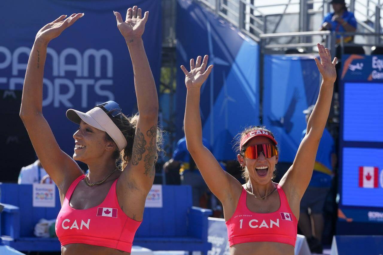 Canada’s Brandie Wilkerson, left, and Melissa Humana-Paredes, celebrate after defeating Argentina in a women’s beach volleyball semifinal match at the Pan American Games in Santiago, Chile, Thursday, Oct. 26, 2023. THE CANADIAN PRESS/AP-Esteban Felix