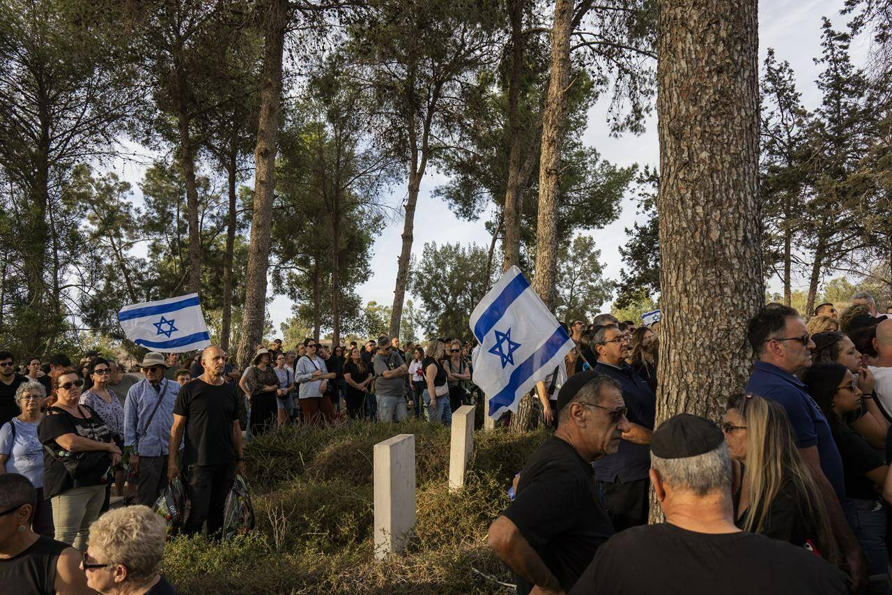 Relatives and friends attend the funeral of Lili Itamari and Ram Itamari in Rukhama cemetery, south Israel, Sunday, Oct. 29, 2023. Lili and Ram Itamari were killed during the Hamas attack on Oct. 7, in Kfar Azza near the border with the Gaza Strip. (AP Photo/Bernat Armangue)
