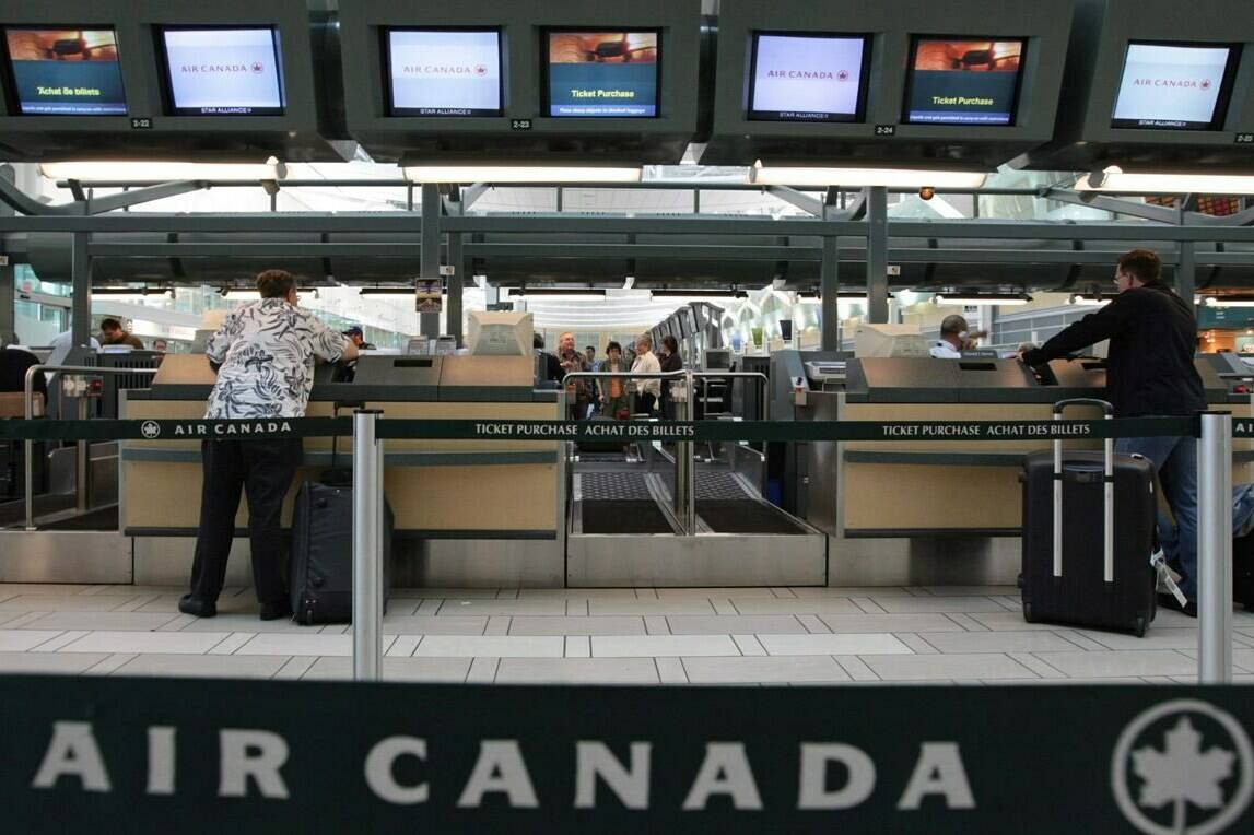 Air Canada passengers check in at the Vancouver International Airport on June 17, 2008. Air Canada says the country’s passenger rights overhaul will hardly hurt its bottom line.THE CANADIAN PRESS/Darryl Dyck