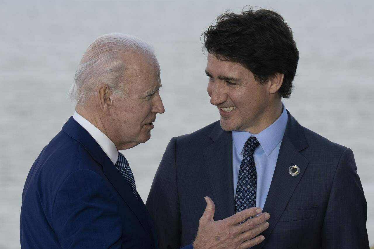 Prime Minister Justin Trudeau is headed to the U.S. capital for a summit meeting to talk about growing trade connections across the Western Hemisphere. Trudeau talks with United States President Joe Biden during a family photo with G7 leaders and outreach countries and international organizations Saturday, May 20, 2023 in Hiroshima, Japan. THE CANADIAN PRESS/Adrian Wyld