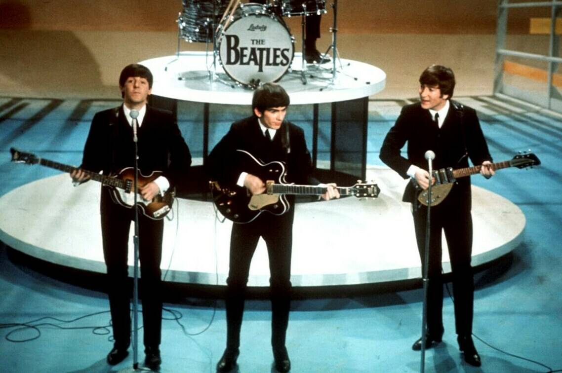 FILE -The Beatles, foreground from left, Paul McCartney, George Harrison, John Lennon and Ringo Starr on drums perform on the CBS “Ed Sullivan Show” in New York on Feb. 9, 1964. Sixty years after the onset of Beatlemania and with two of the quartet now dead, artificial intelligence has enabled the release of a “new” Beatles song.“Now And Then,” will be available Thursday, Nov. 2. (AP Photo/File)