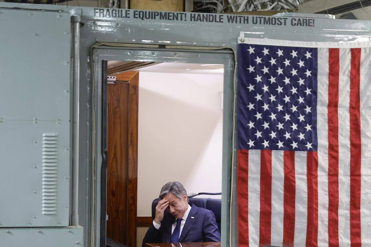 U.S. Secretary of State Antony Blinken sits onboard the plane during his visit to Israel as he departs en route to Jordan, Friday, Nov. 3, 2023. Blinken is in Israel to press for more humanitarian aid to be allowed into besieged Gaza. (Jonathan Ernst/Pool Photo via AP)