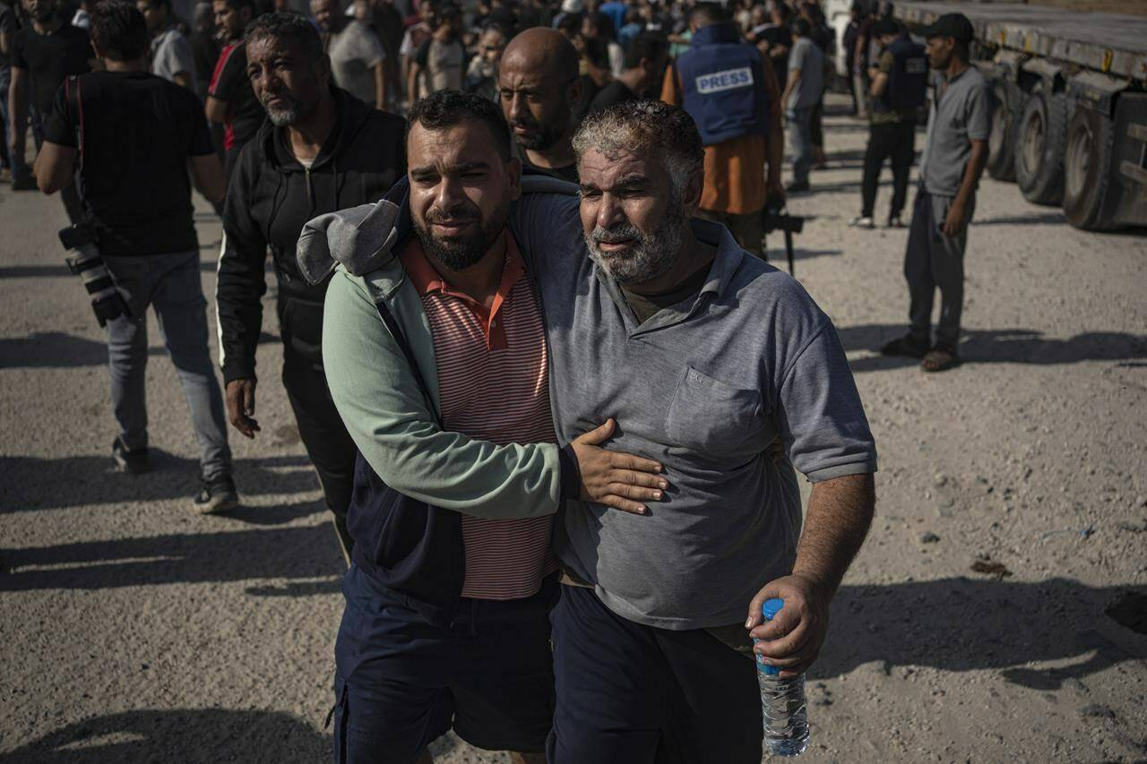 Palestinian day laborers in Israel arrive in the Gaza Strip at the Kerem Shalom crossing after being brought by Israeli authorities Friday, Nov. 3, 2023. Thousands of day laborers from Gaza were in Israel when the war started. (AP Photo/Fatima Shbair)