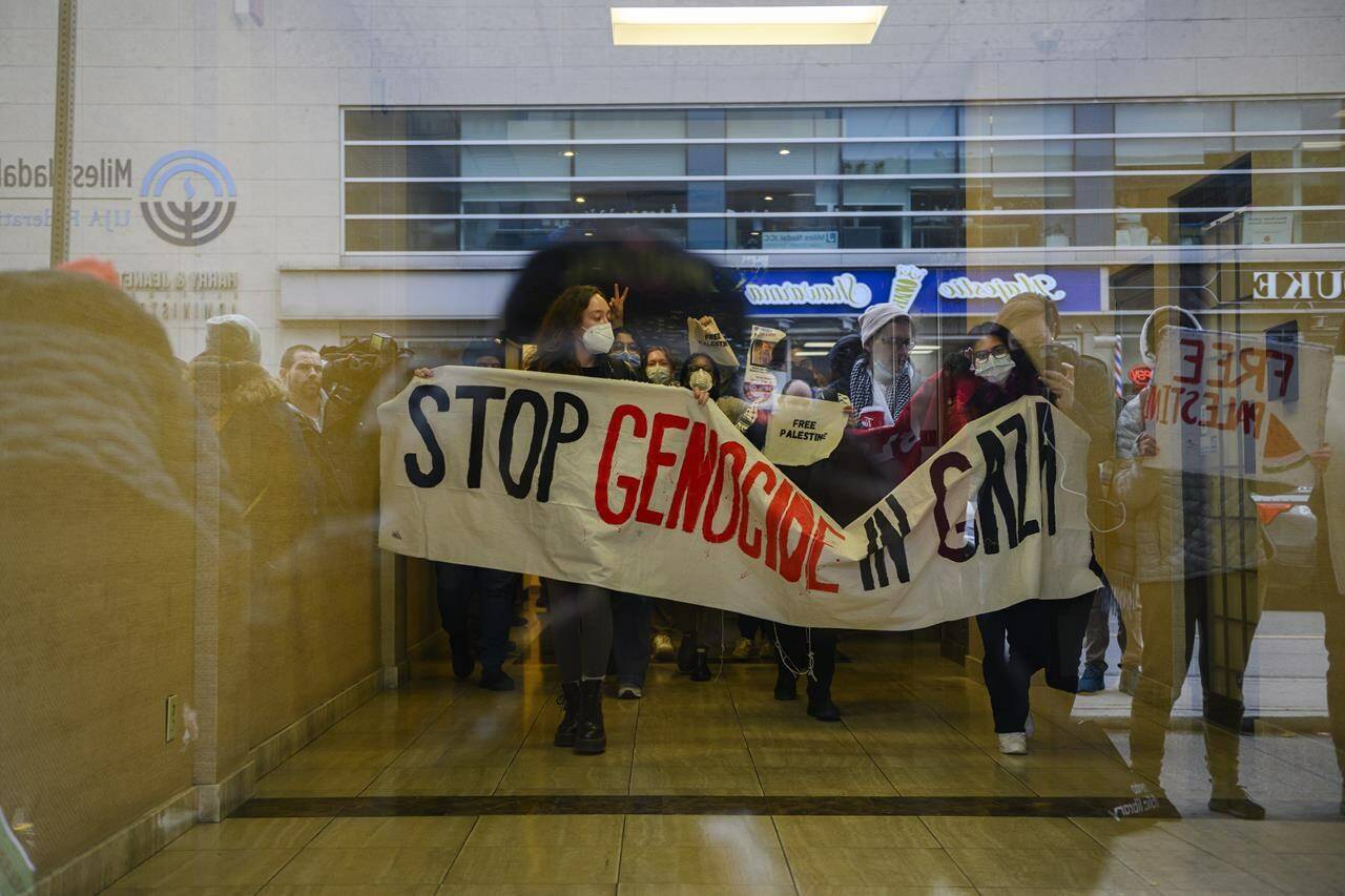 Pro-Palestine demonstrators emerge after a sit-in protest inside of Deputy Prime Minister Chrystia Freeland’s office in Toronto, Monday, Oct., 30, 2023. Demonstrations in support of Gaza are planned in at least two dozen Canadian cities today as the death toll in the Palestinian territory continues to mount. THE CANADIAN PRESS/Christopher Katsarov