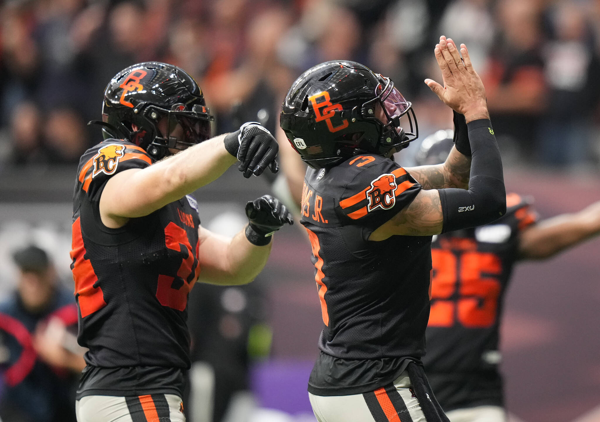 B.C. Lions quarterback Vernon Adams Jr., right, and David Mackie celebrate after Adams Jr. scored a touchdown during the first half of the CFL western semi-final football game against the Calgary Stampeders, in Vancouver, on Saturday, November 4, 2023. THE CANADIAN PRESS/Darryl Dyck