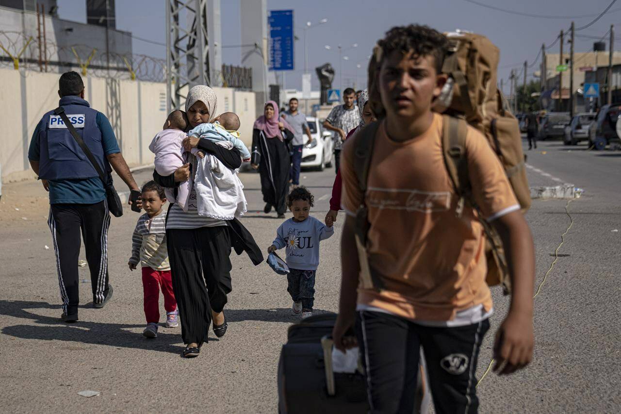 Palestinians arrive at Rafah, the border crossing between the Gaza Strip and Egypt, on Wednesday, Nov. 1, 2023. Canadians awaiting word on when they can leave the war-torn Gaza Strip by crossing into Egypt still don’t appear to have the green light to begin their journey home. THE CANADIAN PRESS/AP, Fatima Shbair