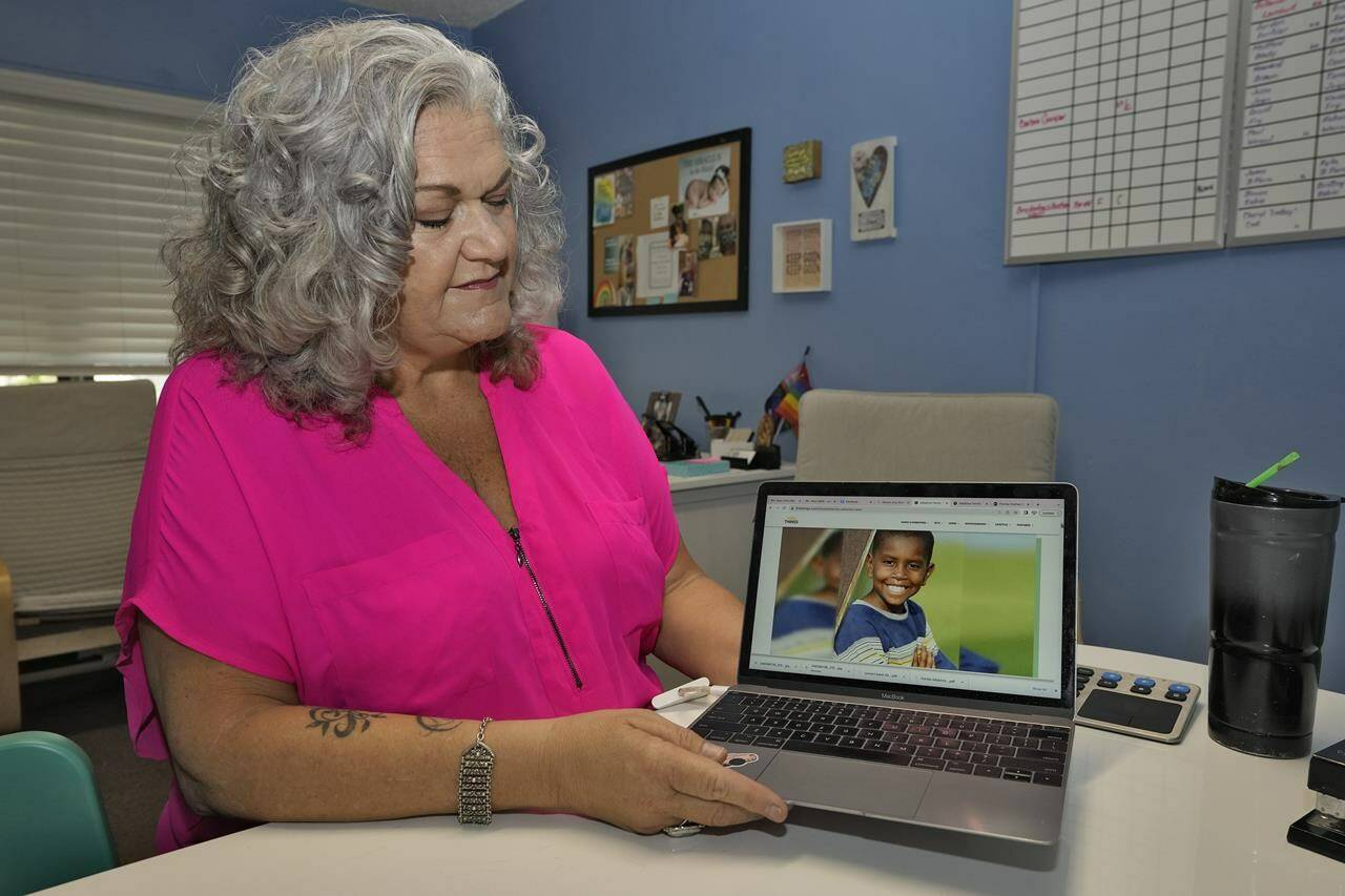 Longtime Florida social worker Connie Going looks at a computer screen with an image of her adopted son Davion in her adoptions office June 12, 2023, in St. Petersburg, Fla. Going said the Family-Match tool gives false hope to waiting parents by failing to deliver successful matches, and ultimately makes her job harder. (AP Photo/Chris O’Meara)