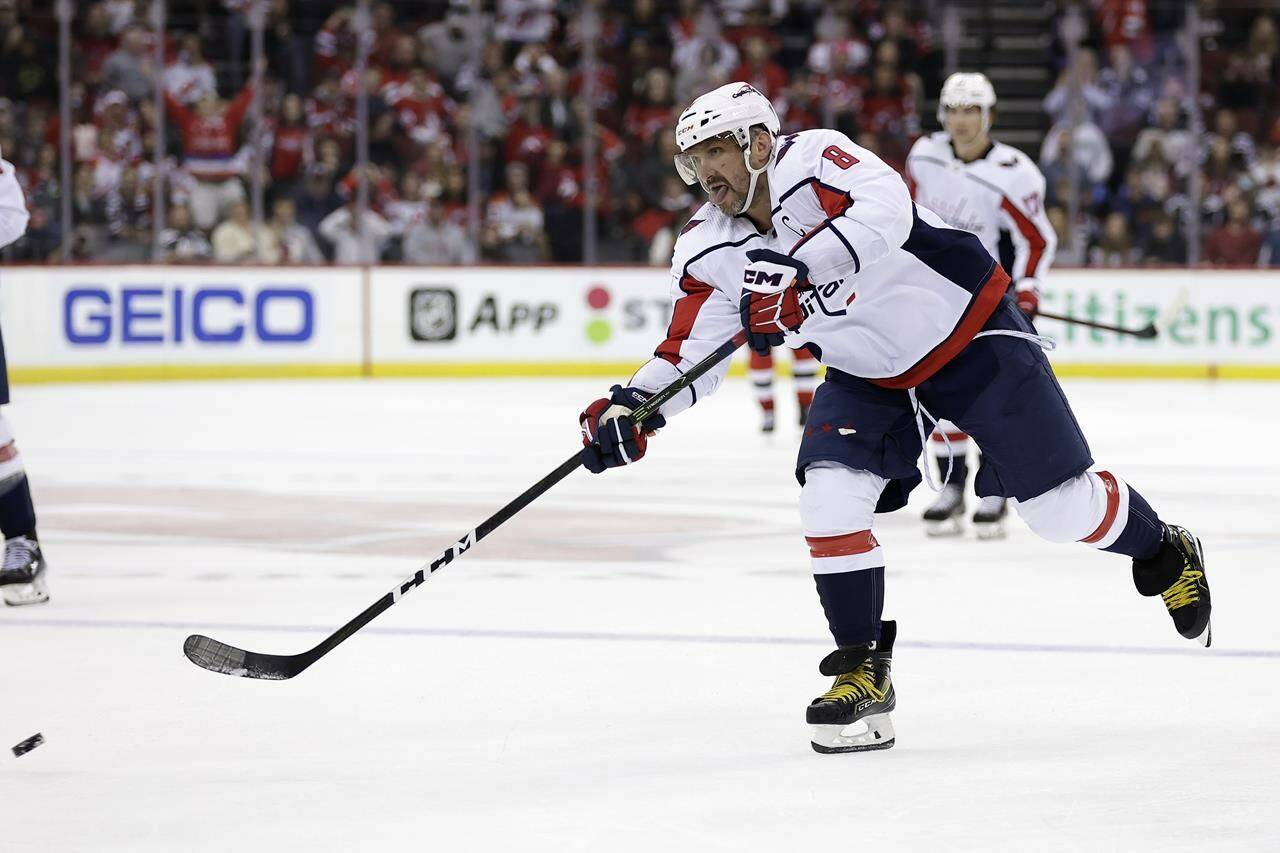 Washington Capitals left wing Alex Ovechkin scores an empty-net goal against the New Jersey Devils during the third period of an NHL hockey game Wednesday, Oct. 25, 2023, in Newark, N.J. (AP Photo/Adam Hunger)