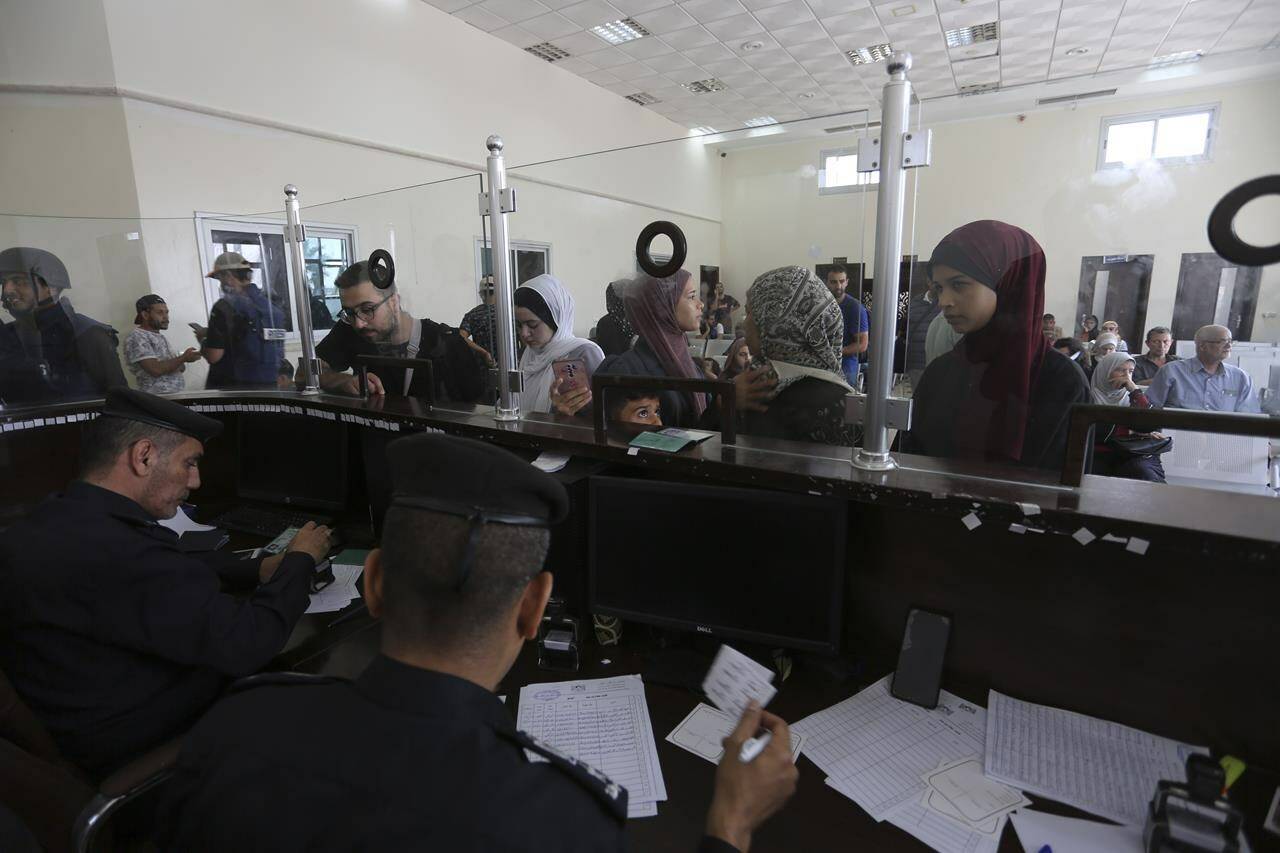 Palestinians with dual nationality register to cross to Egypt on the Gaza Strip side of the border crossing in Rafah on Thursday, Nov. 2, 2023. THE CANADIAN PRESS/AP, Hatem Ali