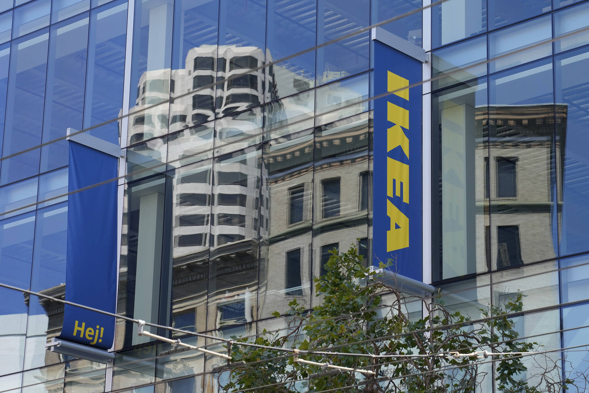 Buildings are reflected in the windows of the new IKEA store on its opening day in San Francisco, Wednesday, Aug. 23, 2023. (AP Photo/Eric Risberg)