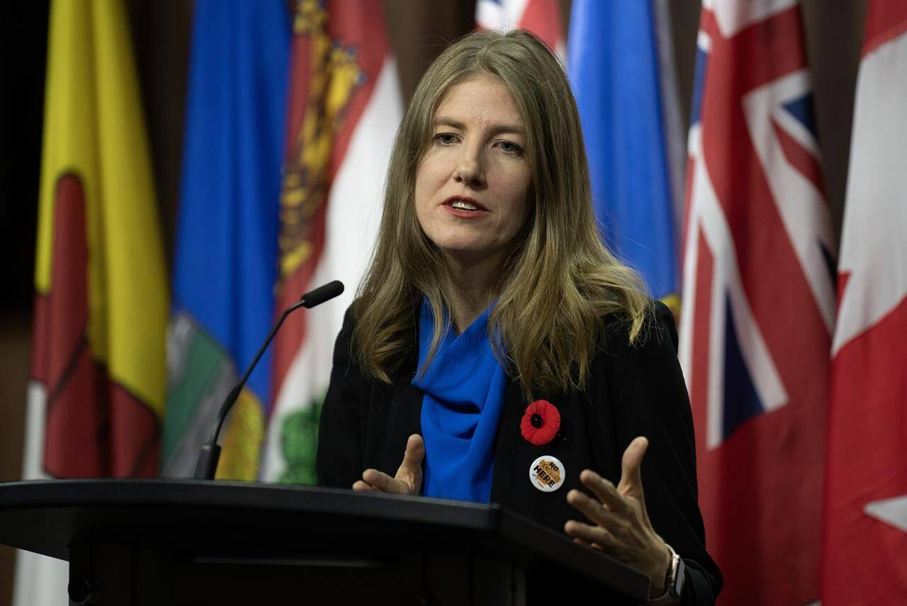 NDP MP for Victoria Laurel Collins speaks about intimate partner violence during a news conference, Thursday, Nov. 9, 2023 in Ottawa. THE CANADIAN PRESS/Adrian Wyld