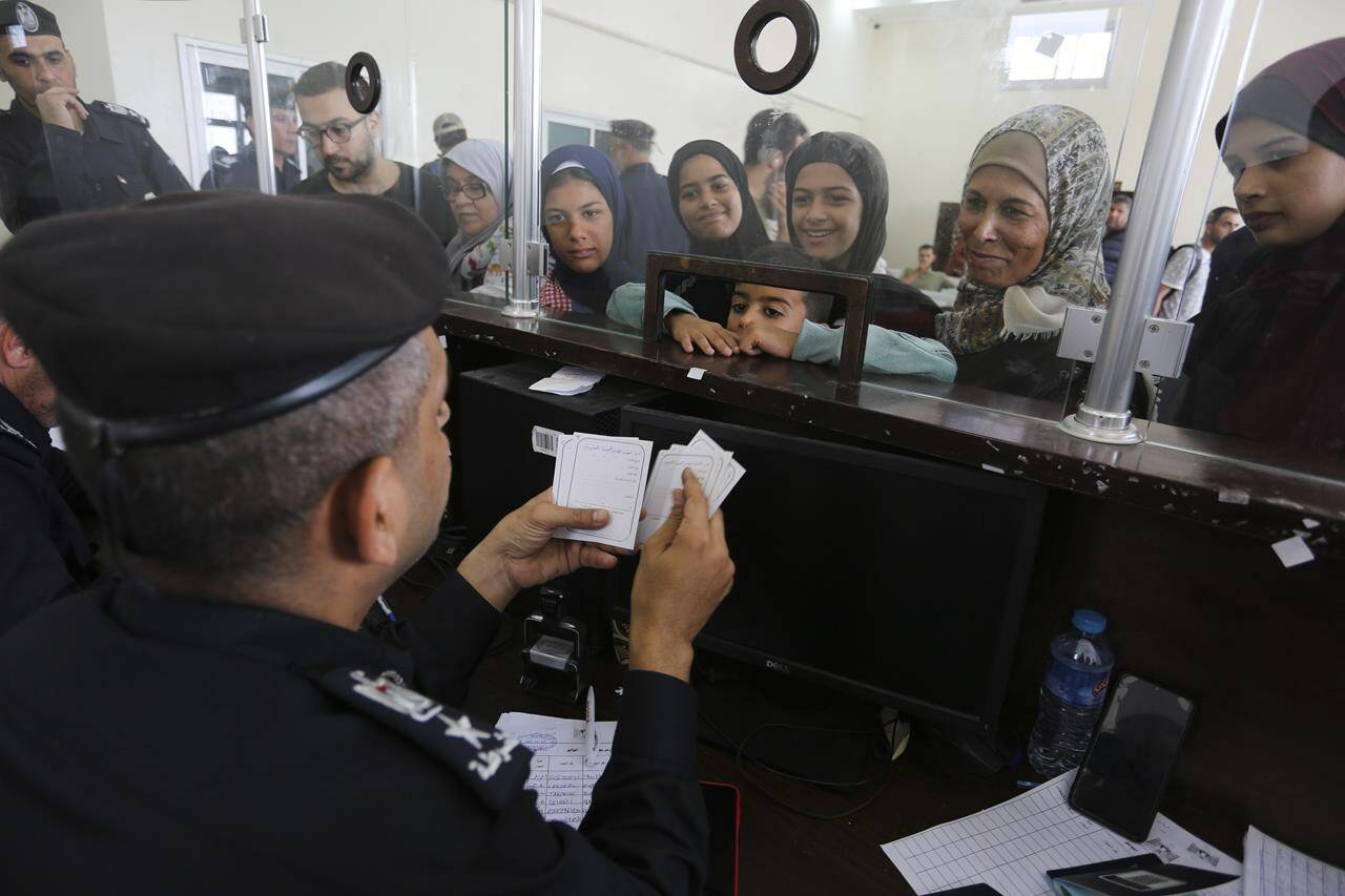 Palestinians with dual nationality register to cross to Egypt on the Gaza Strip side of the border crossing in Rafah on Thursday, Nov. 2, 2023. THE CANADIAN PRESS/AP-Hatem Ali