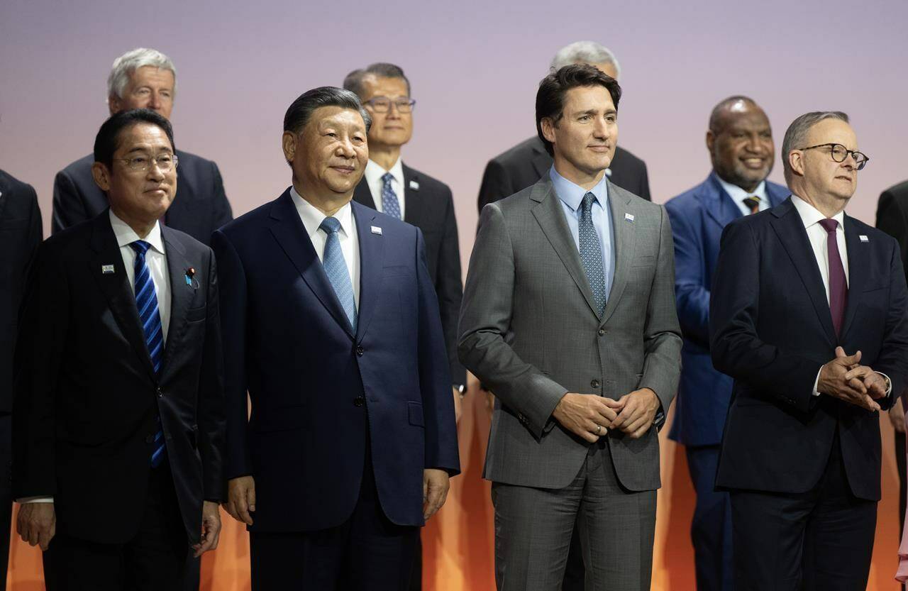Prime Minister Justin Trudeau stands next to Chinese President Xi Jinping and other leaders for the family photo at the APEC Summit, in San Francisco, Calif., Thursday, Nov. 16, 2023. THE CANADIAN PRESS/Adrian Wyld