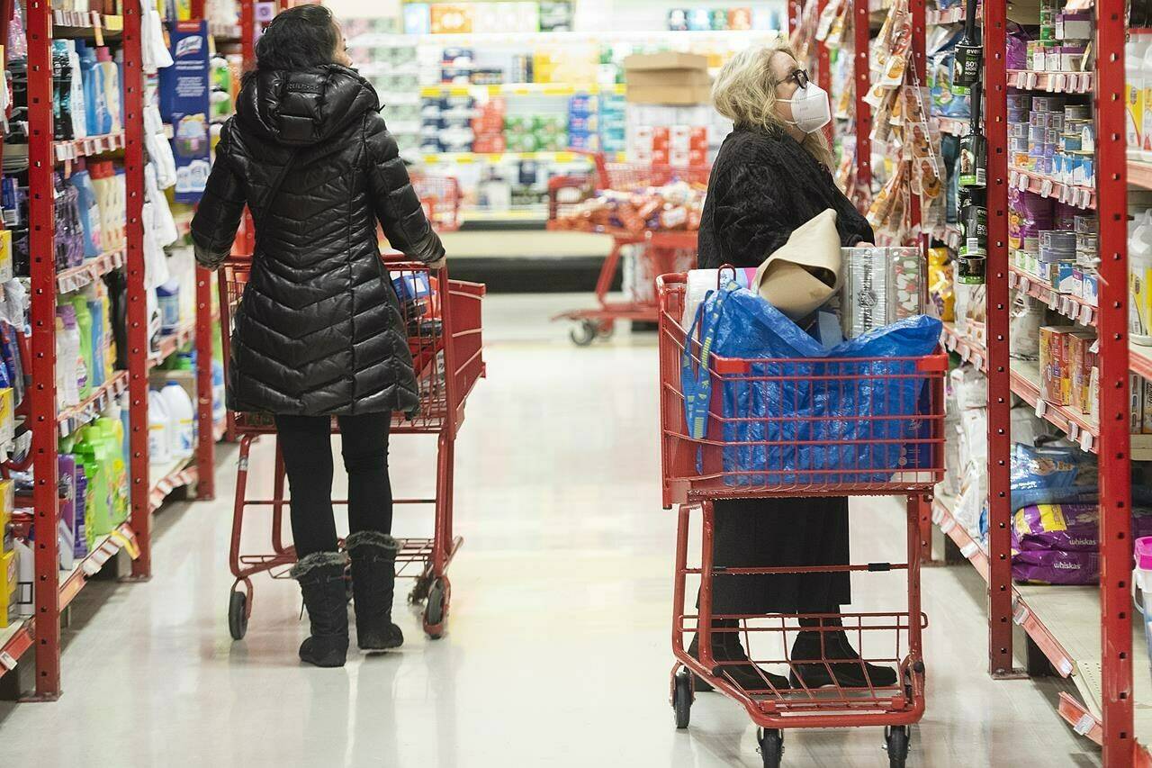 Statistics Canada is expected to release its latest reading on inflation today. People shop in a grocery store in Montreal, Wednesday, Nov. 16, 2022. THE CANADIAN PRESS/Graham Hughes