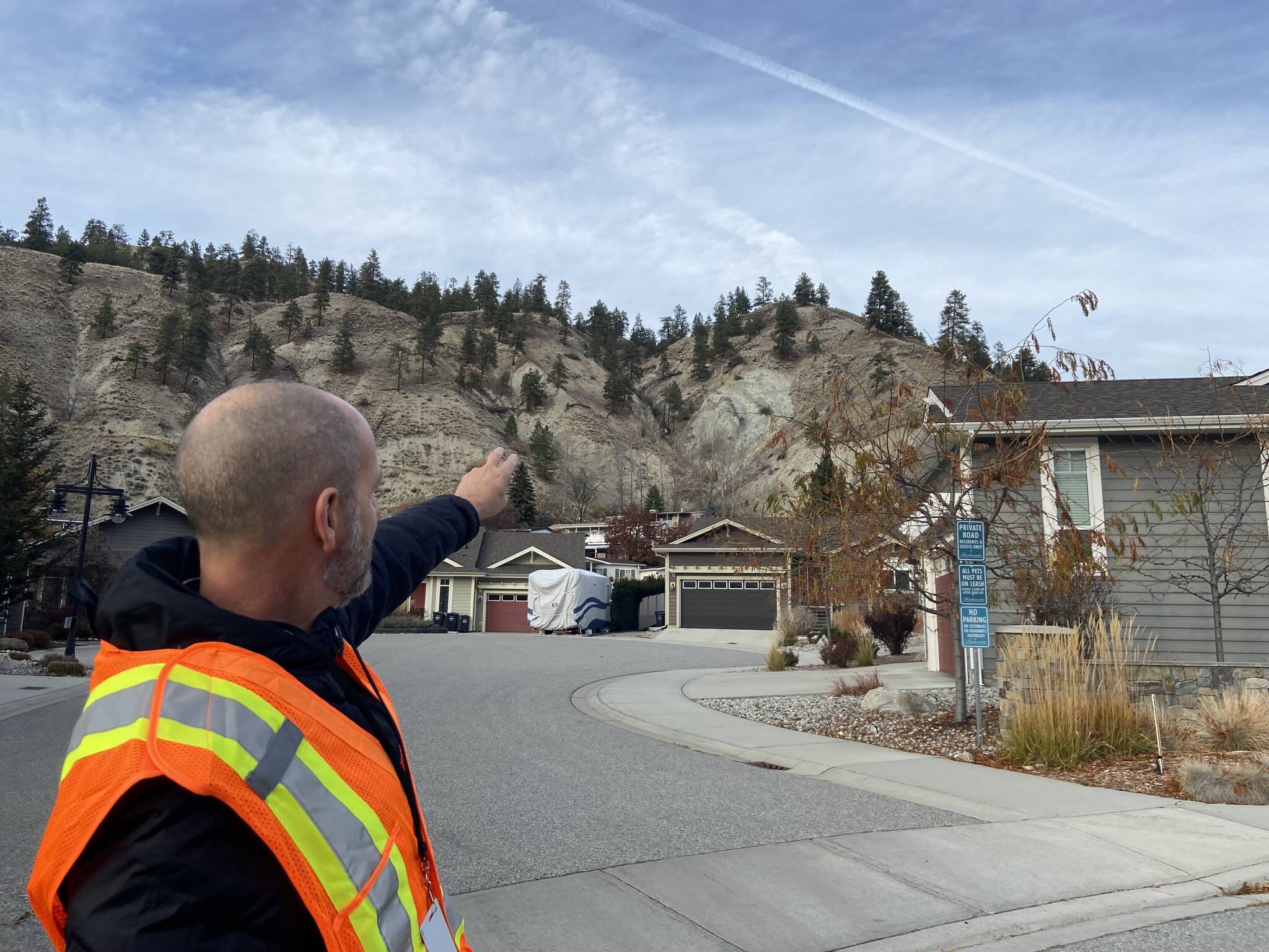 City of Penticton staff member Len Robson points to a rock face that is moving and has potential of breaking away, which lead to evacuations for 24 properties on Penticton Avenue. (Monique Tamminga - Western News)