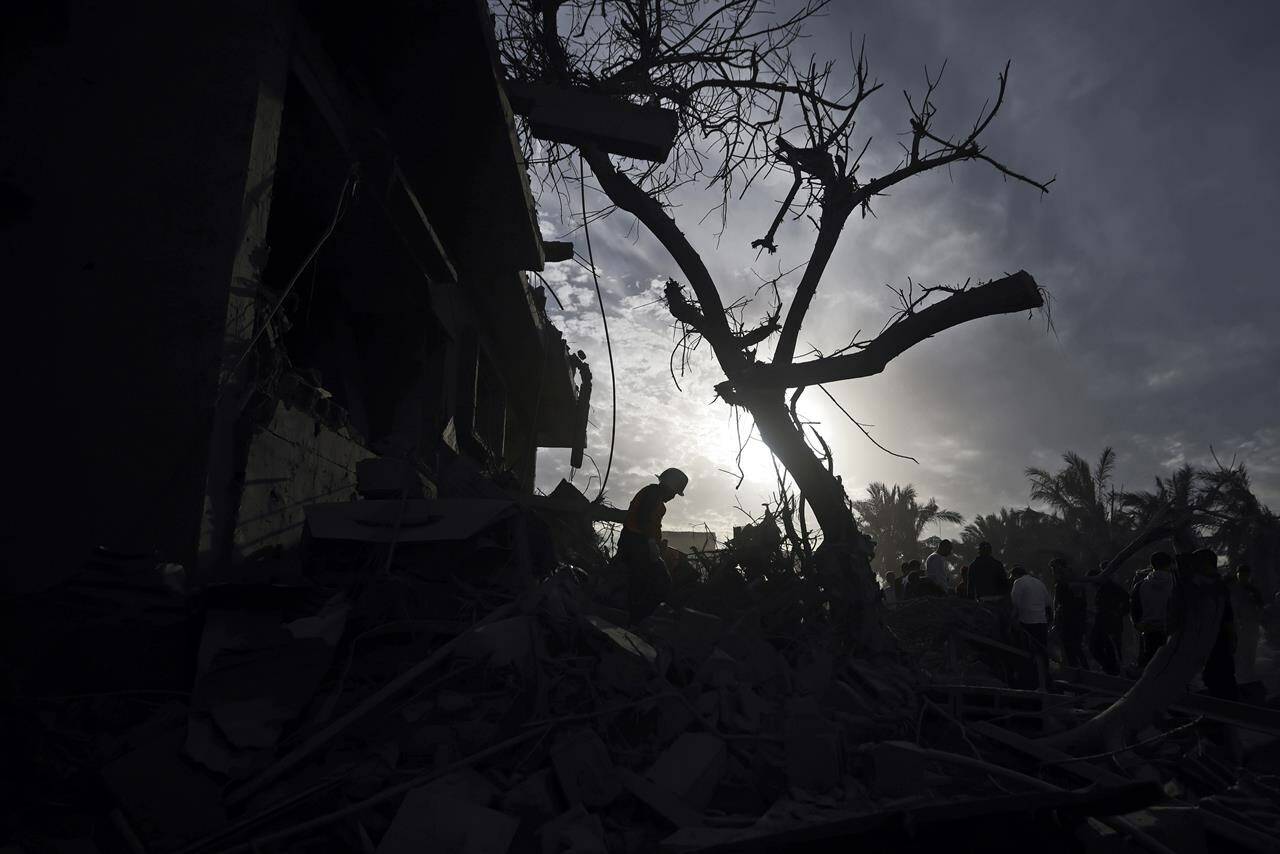 Palestinians inspect the damage of a destroyed house following Israeli airstrikes in the town of Khan Younis, southern Gaza Strip, Wednesday, Nov. 22, 2023. A four-day truce announced Wednesday will free dozens of Israeli hostages held by militants as well as Palestinians imprisoned in Israel. It will also bring a large influx of aid to the besieged territory.THE CANADIAN PRESS/AP-Mohammed Dahman