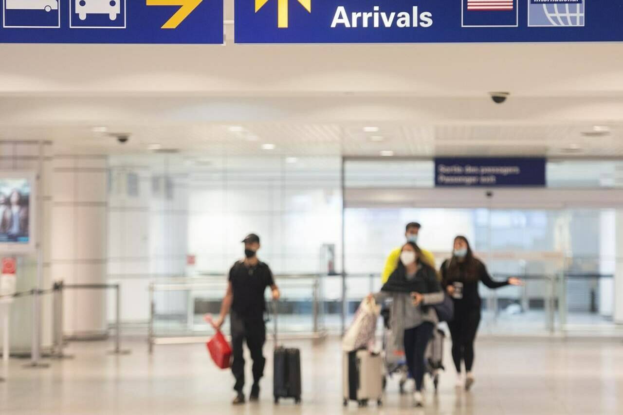 A clear majority of Canadians say higher immigration is fuelling the housing crisis and putting pressure on the health care system, a new Leger poll suggests. Travellers arrive at Trudeau Airport in Montreal, Wednesday, April 20, 2022. THE CANADIAN PRESS/Graham Hughes