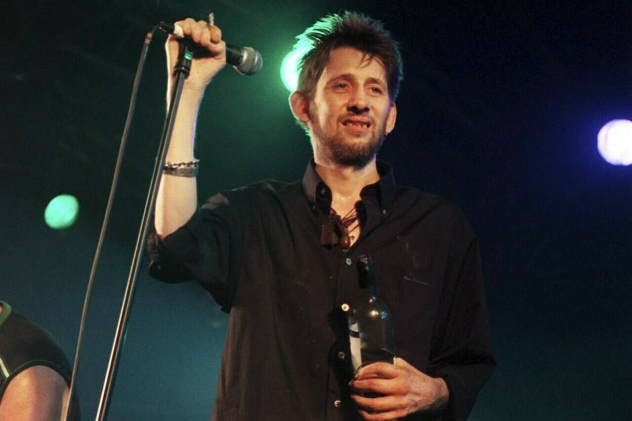 FILE - Former Pogues member Shane MacGowan performs on stage with his group The Popes, at the 10th annual Fleadh, in Finsbury Park, north London, July 10, 1999. Macgowan, the singer-songwriter and frontman of The Pogues, best known for their ballad “Fairytale of New York,” has died. He was 65. His family said in a statement that “it is with the deepest sorrow and heaviest of hearts that we announce the passing of our most beautiful, darling and dearly beloved Shane Macgowan.” The singer died peacefully early Thursday, Nov. 30, 2023 with his family by his side, the statement added. (Michael Walter/PA via AP, File)