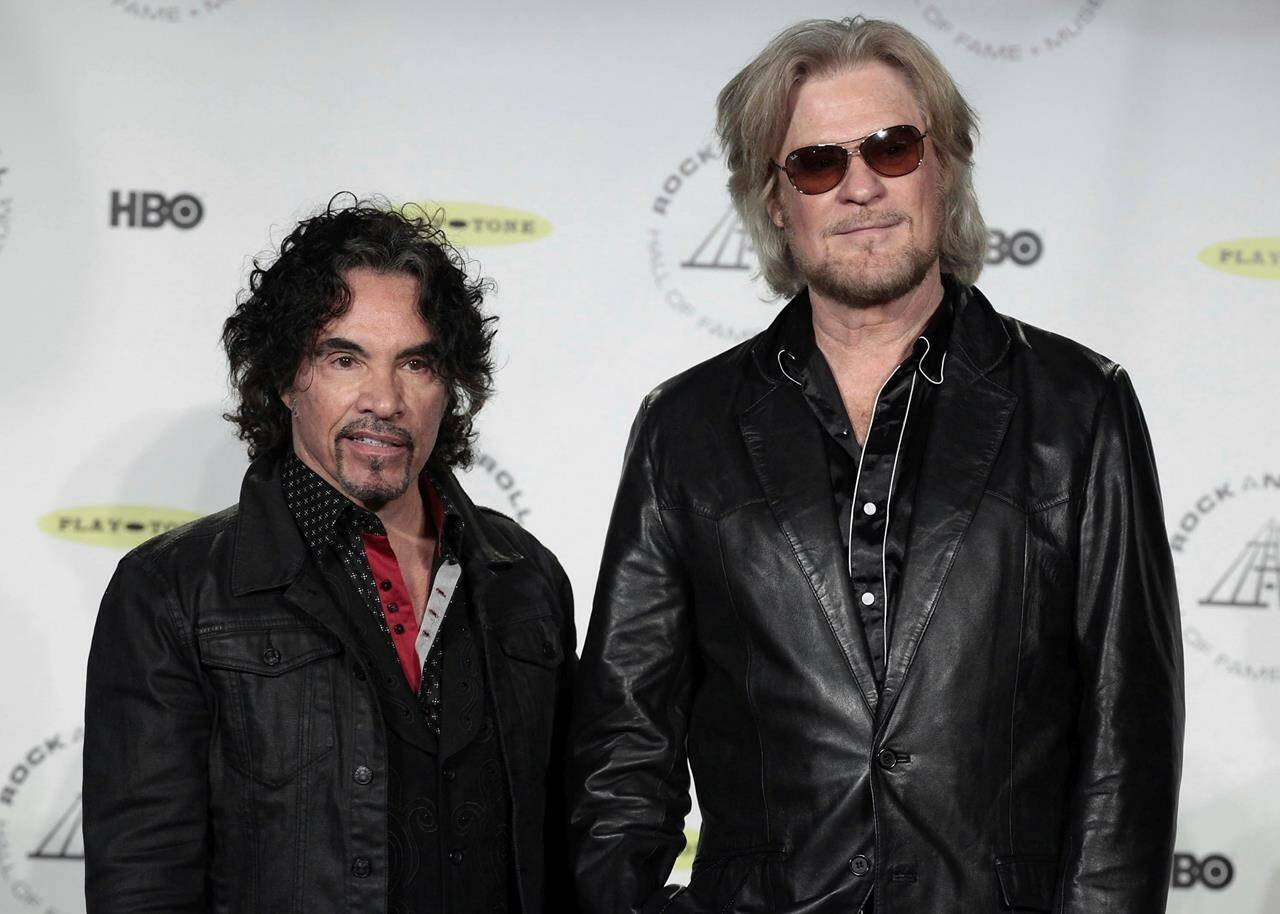 FILE - Hall of Fame Inductees, Hall & Oates, John Oates and Daryl Hall appear in the press room at the 2014 Rock and Roll Hall of Fame Induction Ceremony on April, 10, 2014, in New York. Hall has sued his longtime music partner John Oates, arguing that his plan to sell off his share of a joint venture would violate a business agreement the duo had. (Photo by Andy Kropa/Invision/AP, File)